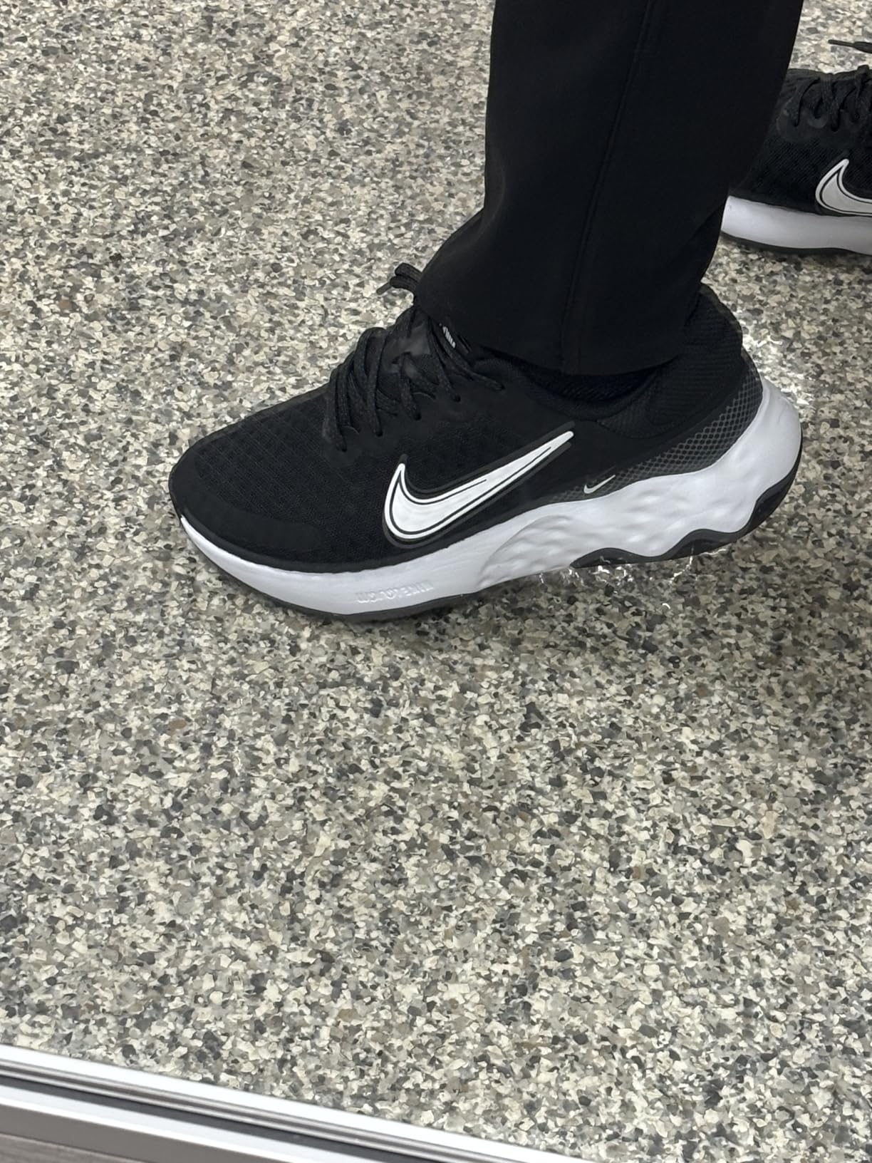 Nike Women's Renew Ride 3 side profile in action showing rubber outsole traction pattern and full shoe silhouette