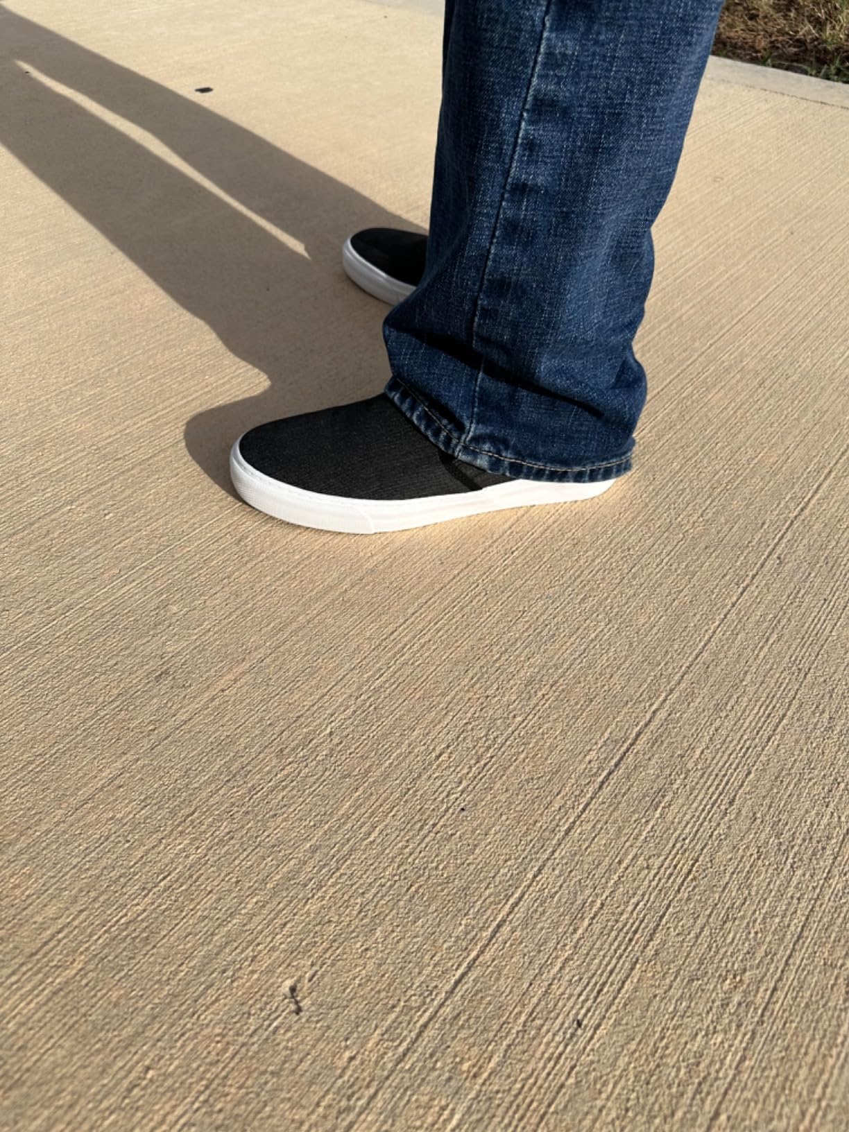 Close-up detail of canvas texture, elastic panels, and vulcanized sole on Men's Classic Low Top Slip-On Sneakers