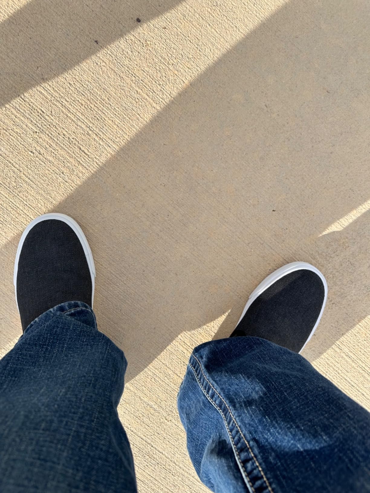 On-feet lifestyle shot showing Men's Classic Low Top Slip-On Canvas Sneakers in daily wear context