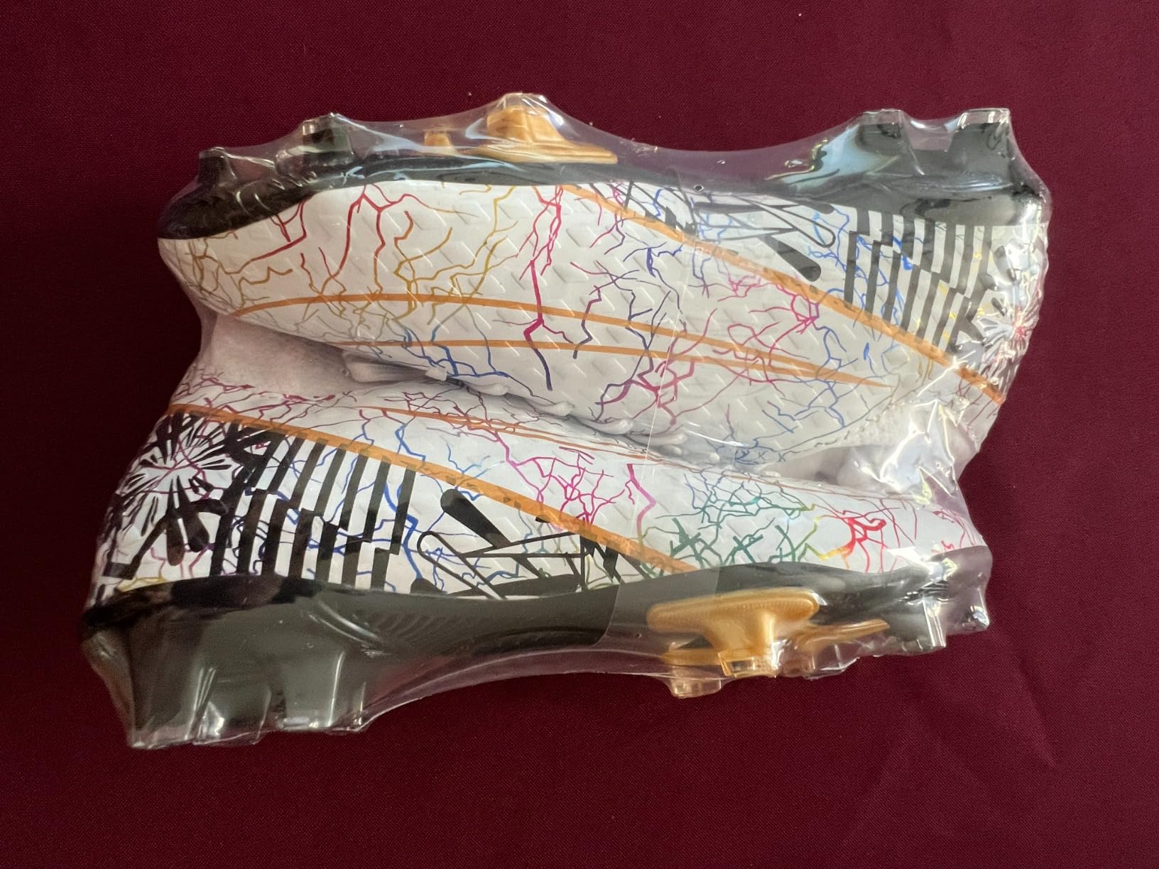 Youth cleats shown on multiple surface types demonstrating versatility