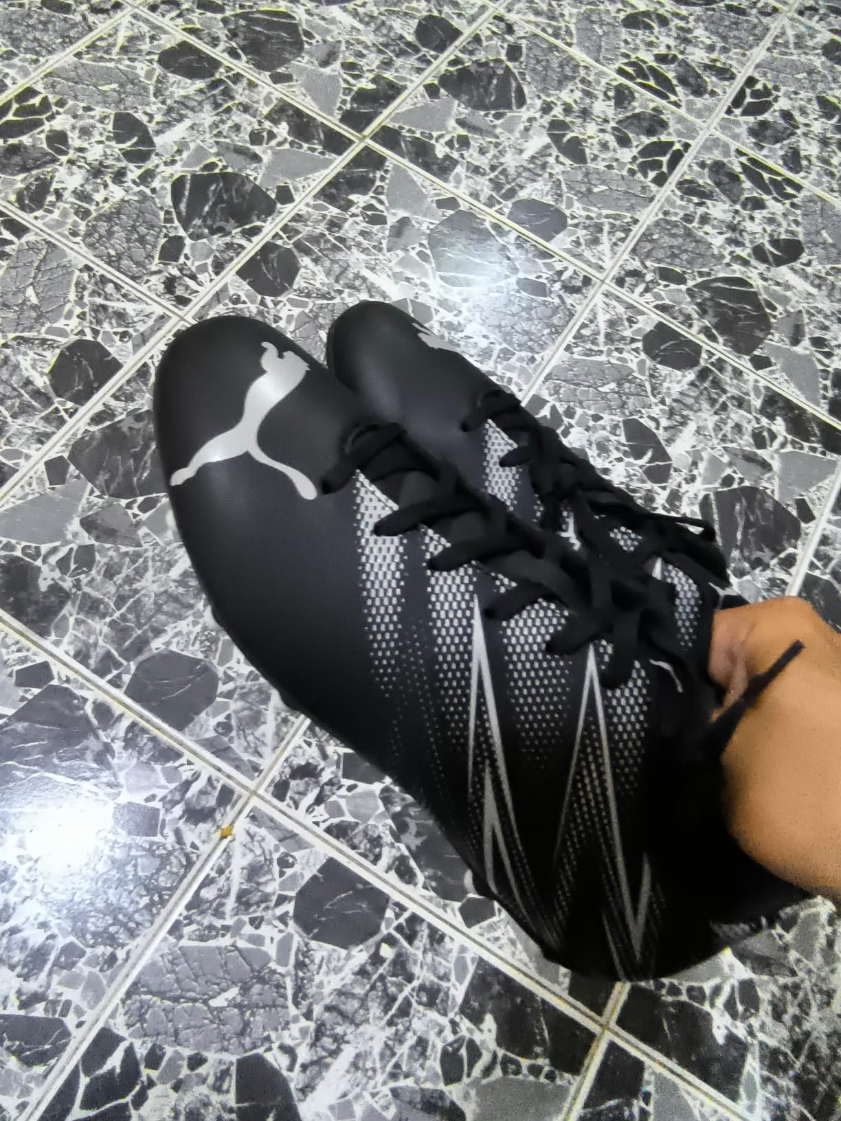 PUMA Men's Attacanto soccer cleats black and silver showing firm ground stud configuration and overall design