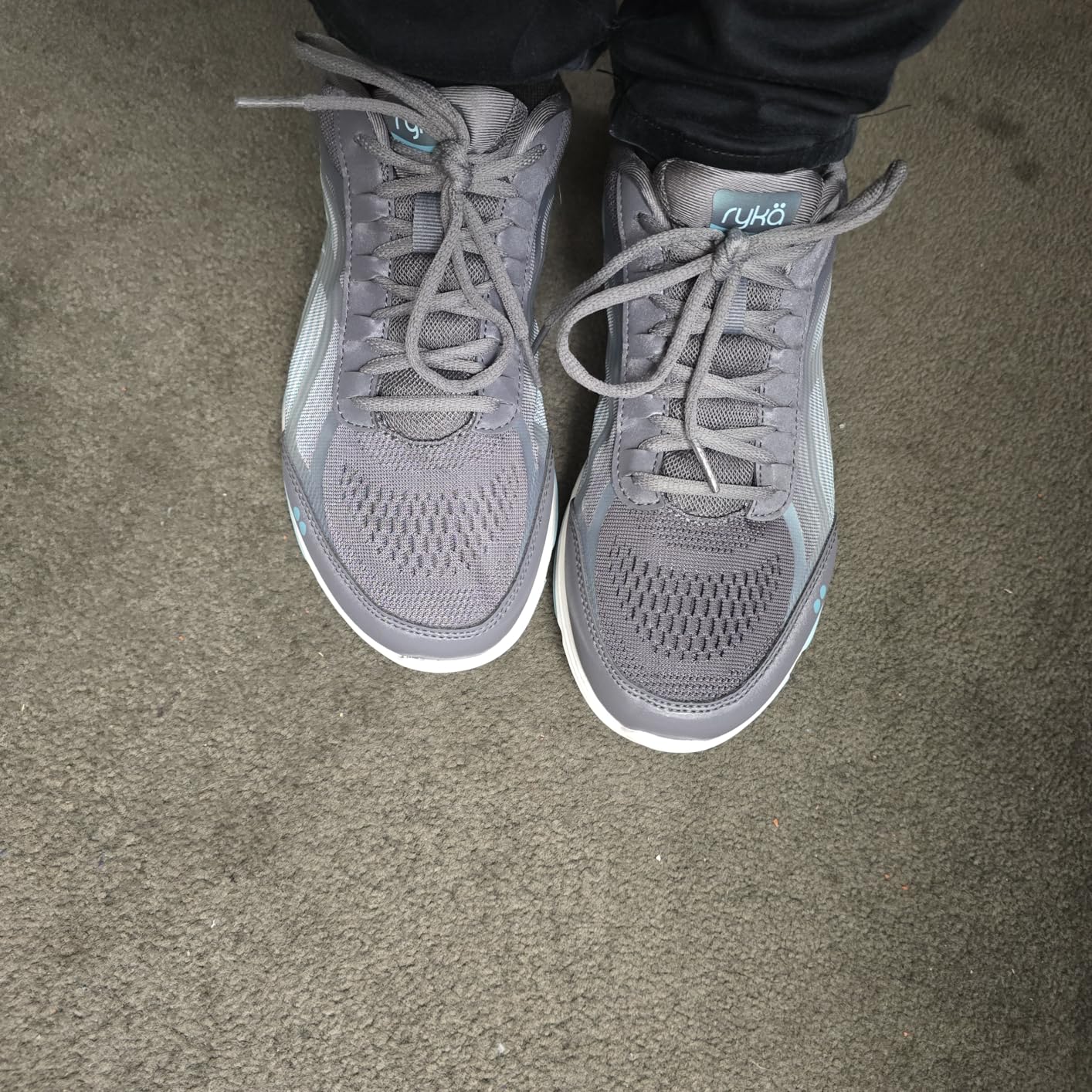 Close-up detail view of Ryka Devotion Plus 3 showing engineered mesh construction and iridescent overlay materials