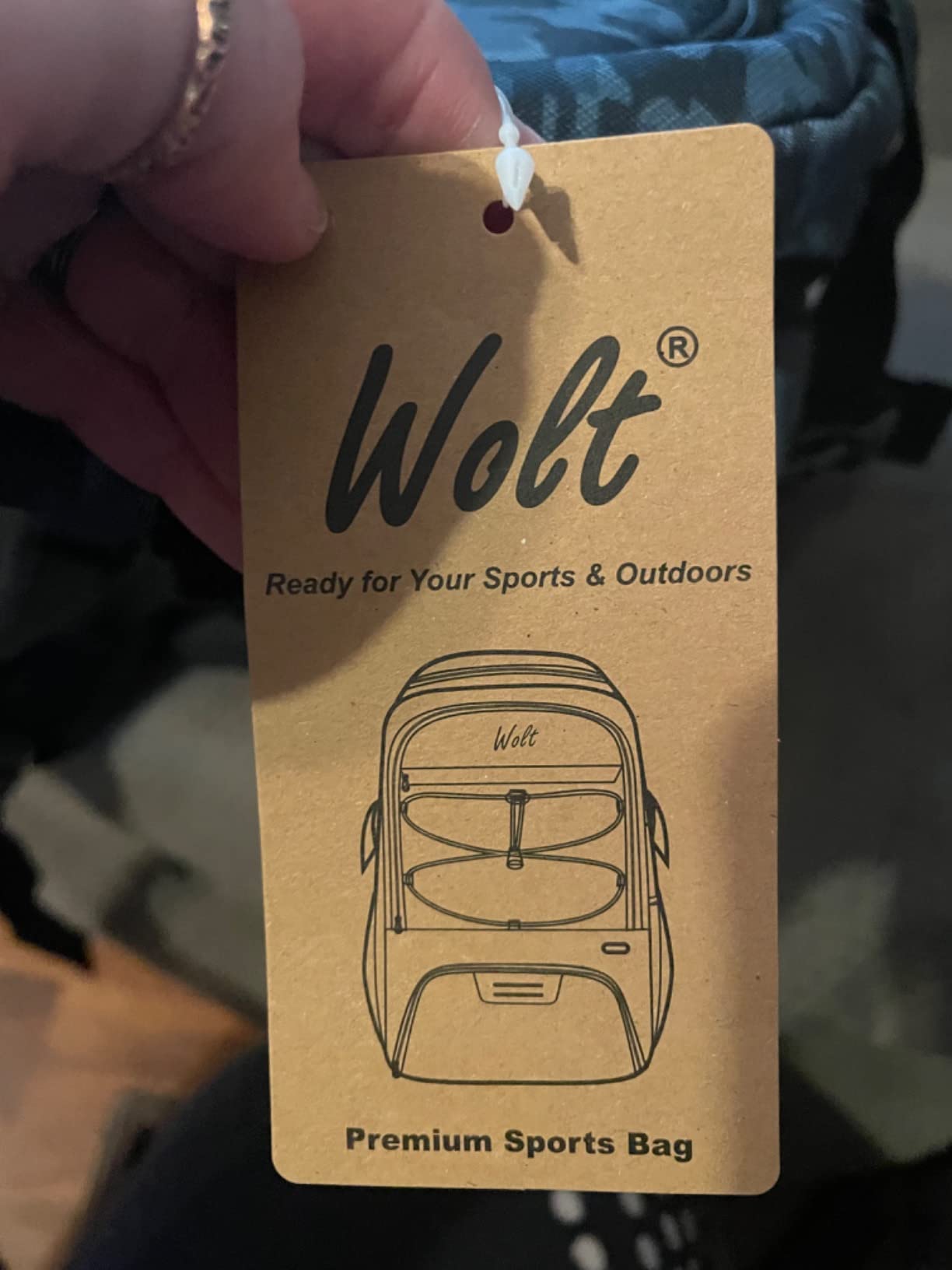 WOLT Basketball Backpack side view showing mesh water bottle pockets and external bungee cord organization features