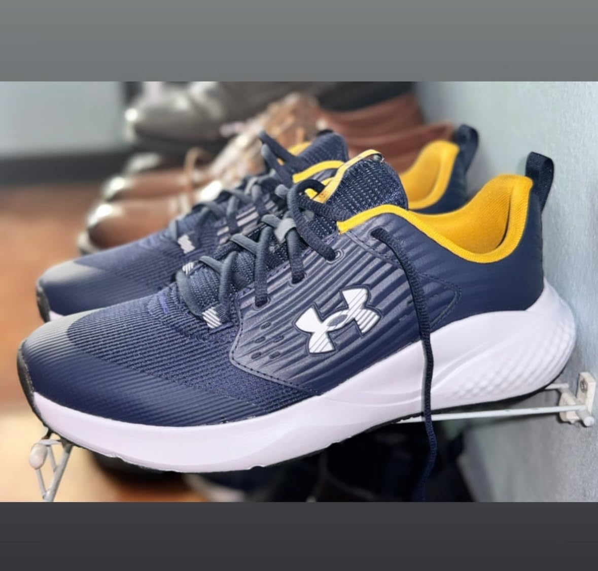 Under Armour Charged Commit Trainer 4 — Upper construction and heel lockdown detail