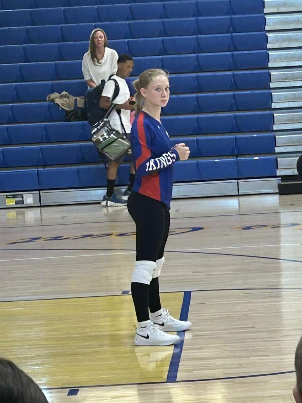 Action shot of Nike volleyball shoes on court during practice showing grip and stability during lateral movements