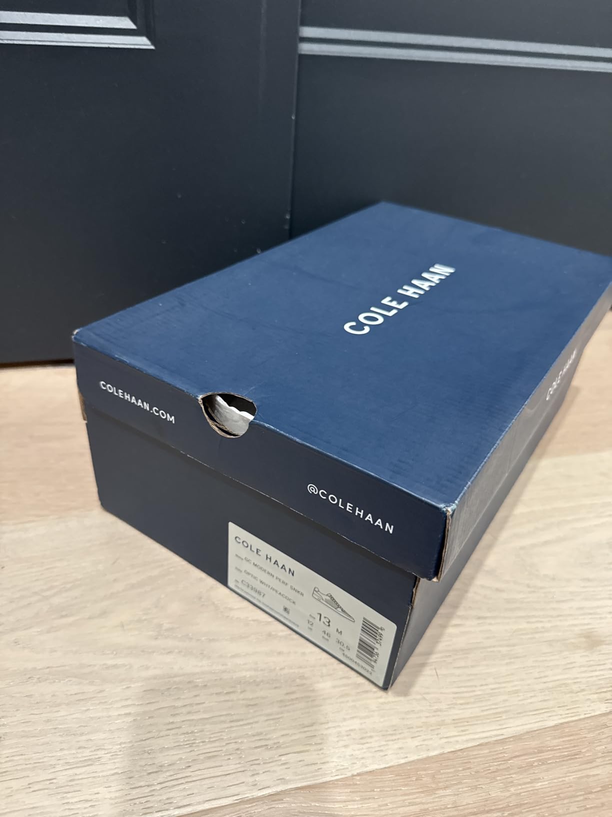 Cole Haan Men's Grand Crosscourt Modern Perforated sneaker showing clean low-profile silhouette in business casual context