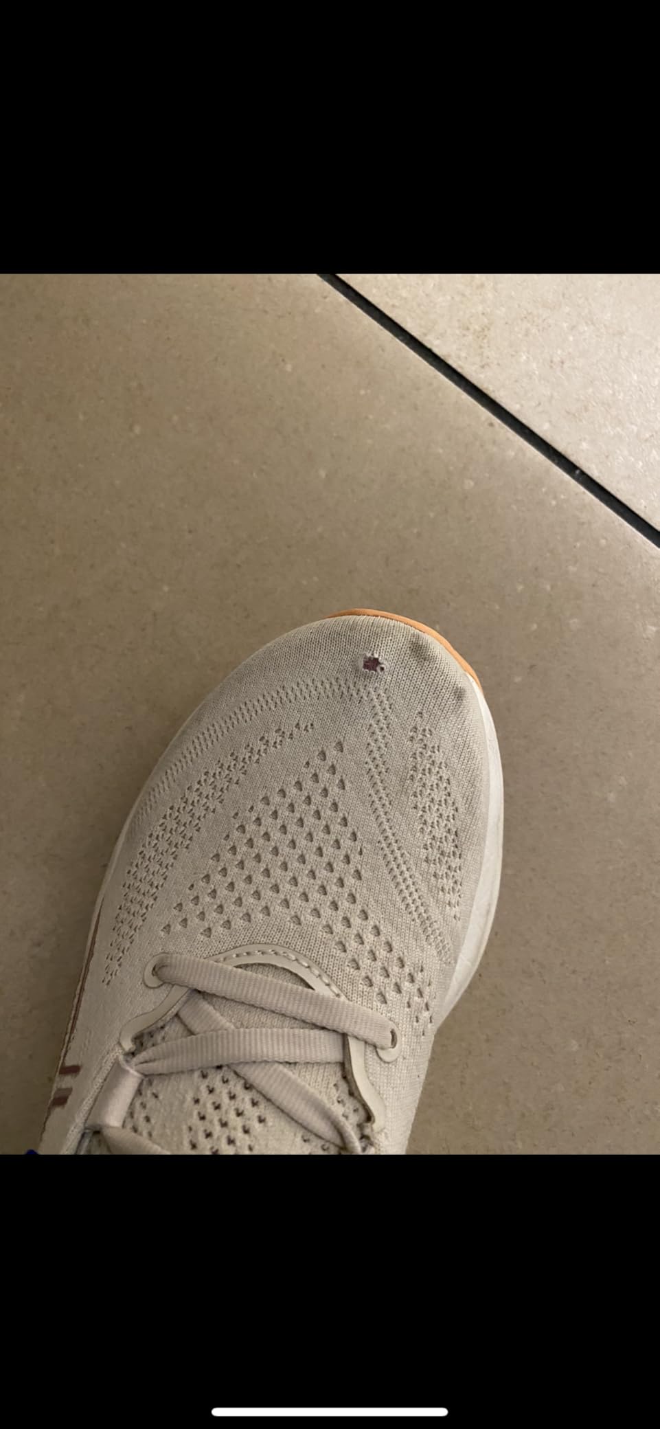 Multiple ASICS Gel-Nimbus 26 shoes showing consistent upper wear patterns across test pairs confirming systemic durability issue
