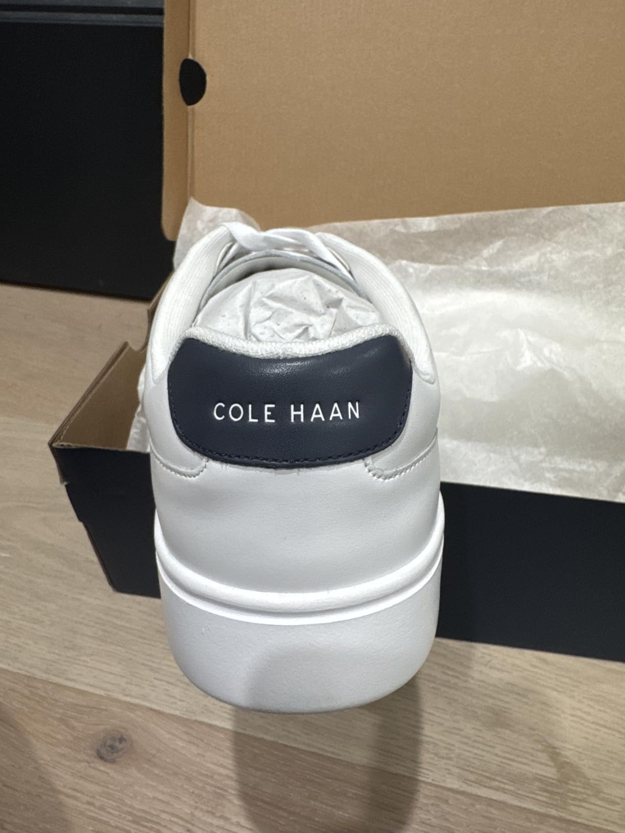 Close-up of Cole Haan Grand Crosscourt laser perforations showing subtle broguing-style design detail on leather upper