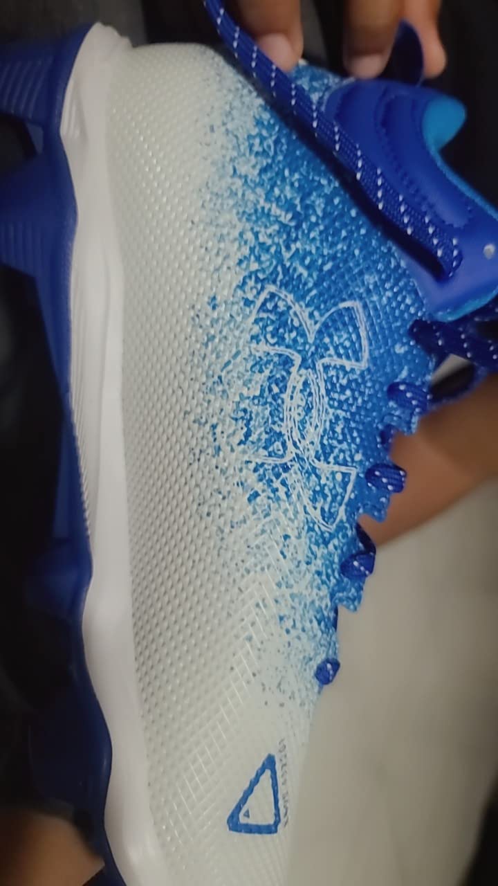 Side profile of Under Armour Spotlight Fran 2.0 showing 5/8 inch ankle height and overall silhouette design for football performance