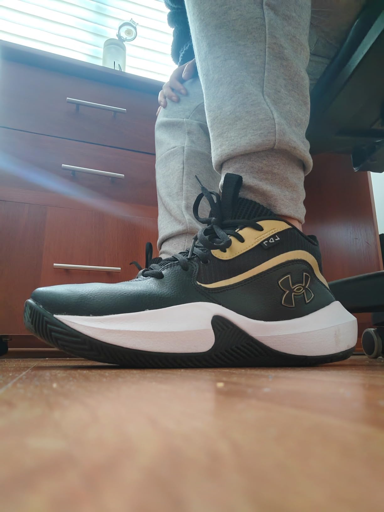 Under Armour Lockdown 7 basketball shoes in action on court demonstrating ankle support and lateral movement
