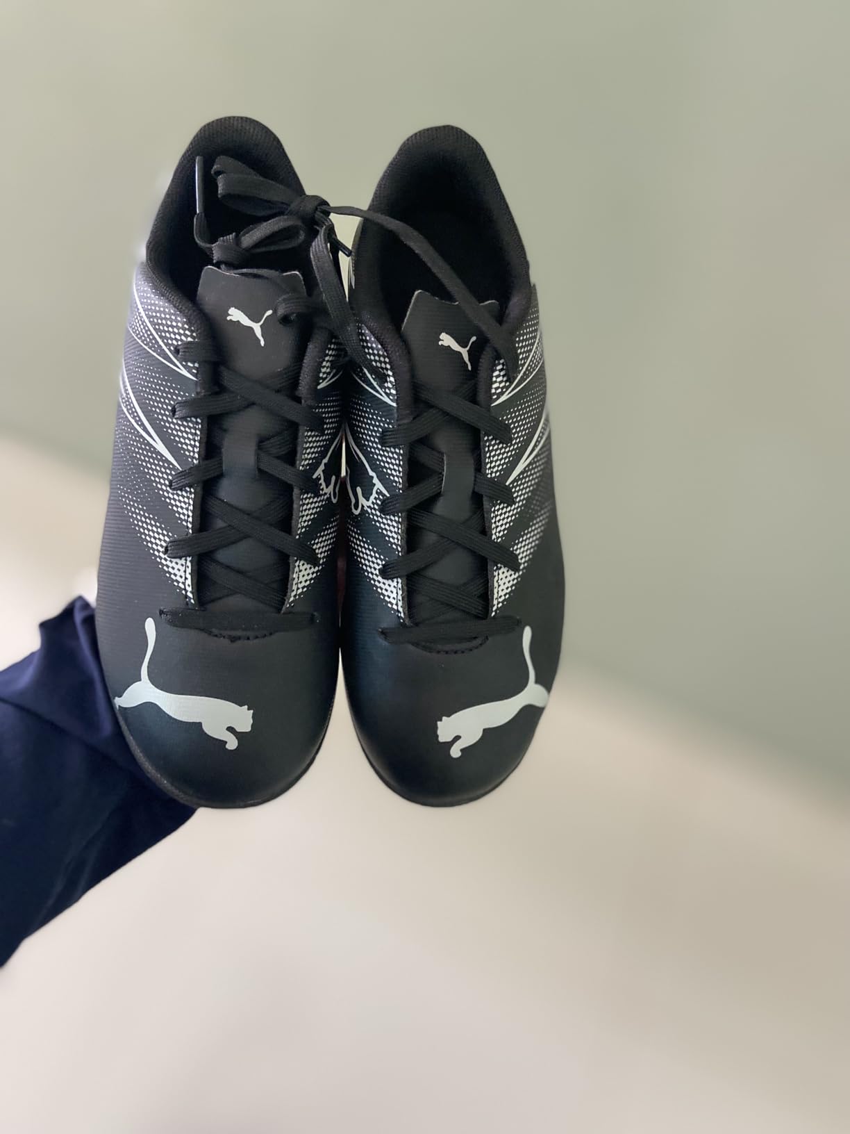 PUMA Attacanto close-up of synthetic upper material and turf sole pattern