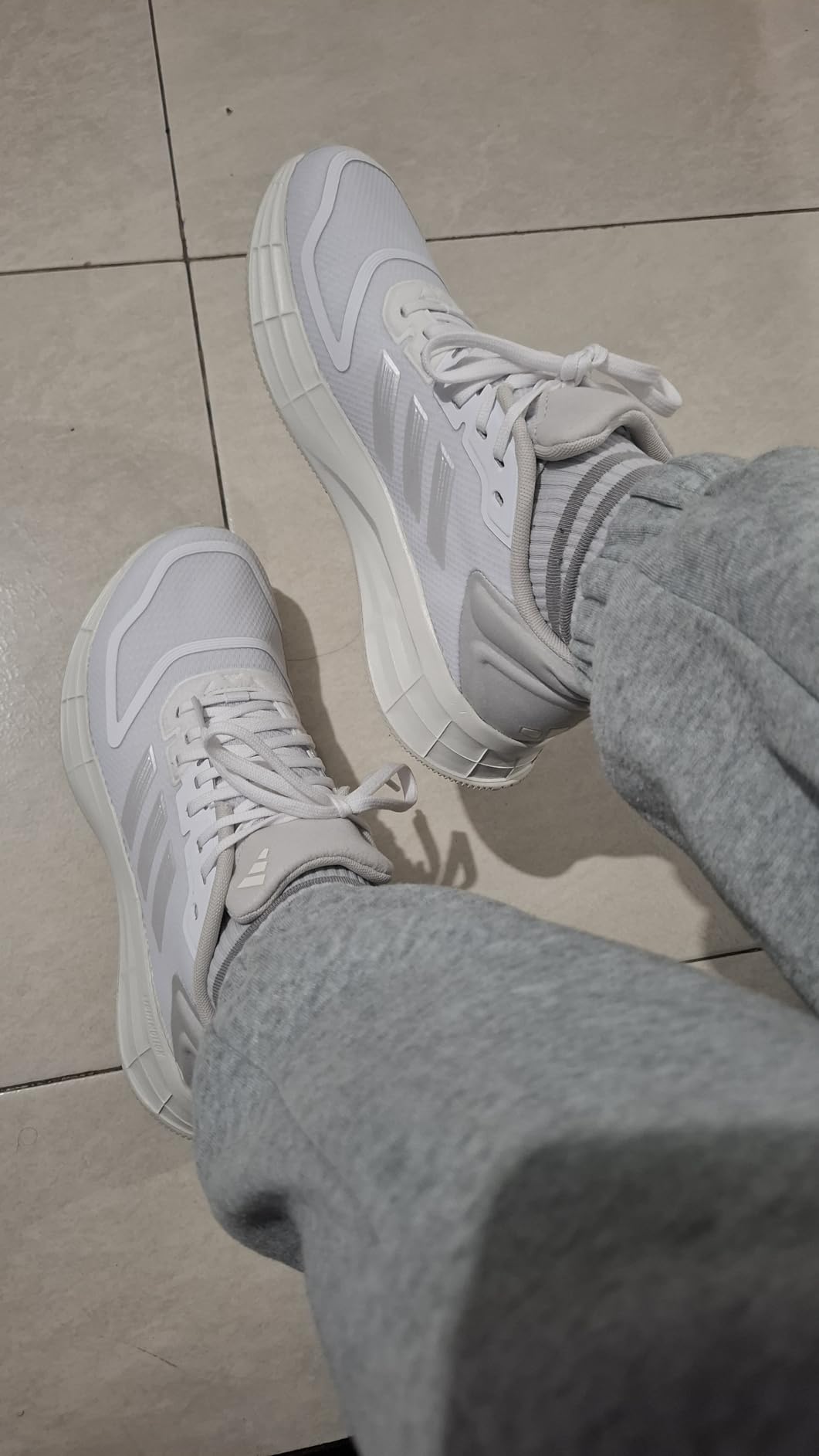 Close-up of Adidas Duramo SL 2.0 mesh upper construction showing breathable textile design and three stripes integration