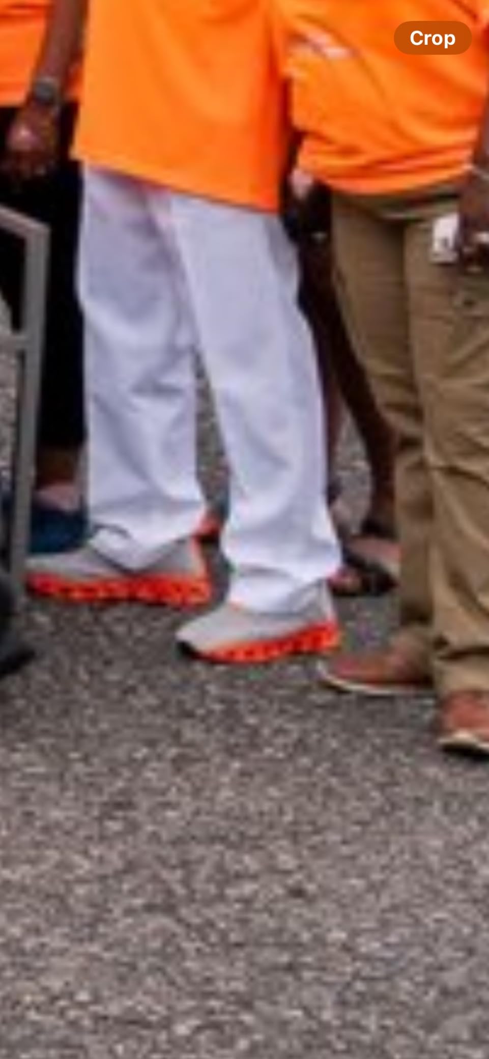Srenket blade sneakers worn casually with orange tee and white pants showing the lifestyle styling potential