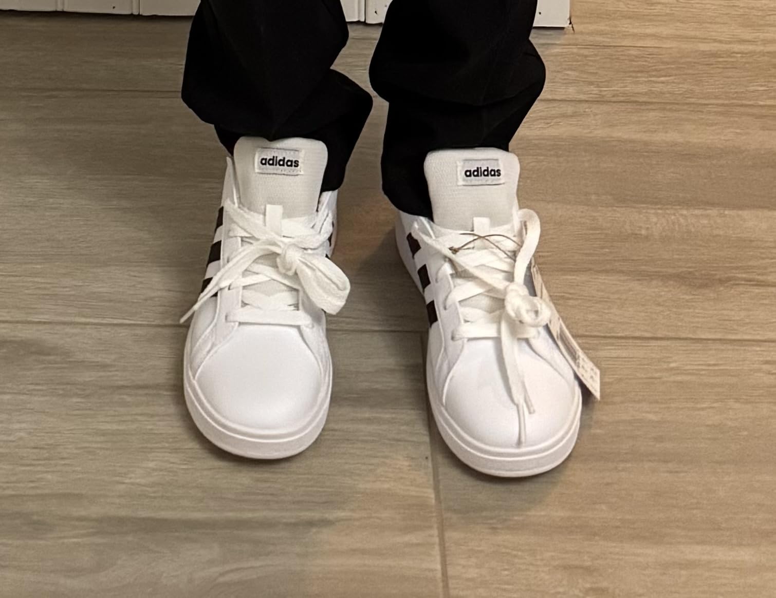 Adidas Grand Court 2.0 kids white sneakers showing classic tennis-inspired design with hook and loop straps