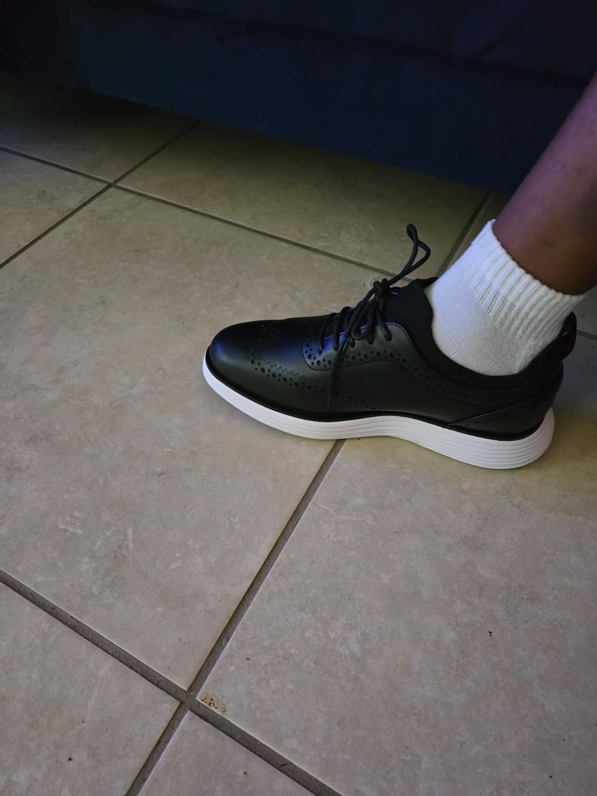 Side profile view showing the chunky sneaker sole beneath the dress shoe upper
