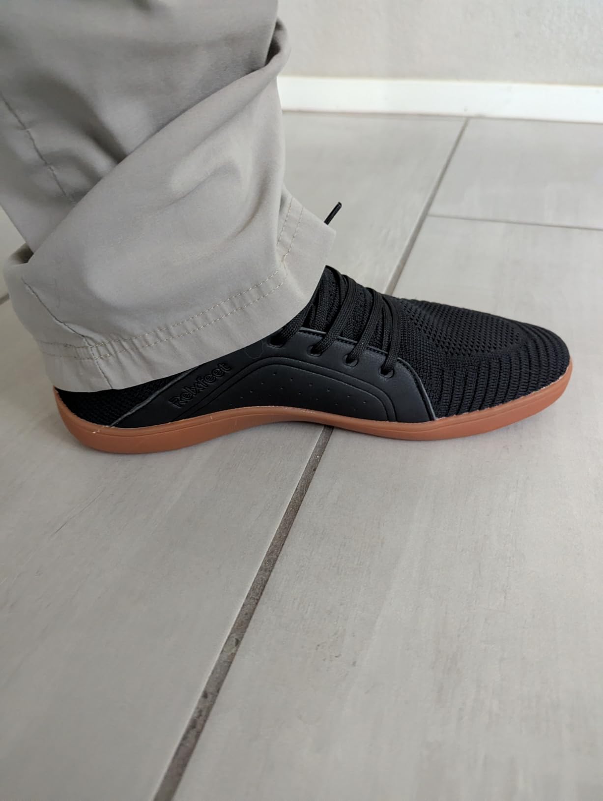 Outdoor testing of Relxfeet barefoot shoes showing sole flexibility on varied terrain surfaces