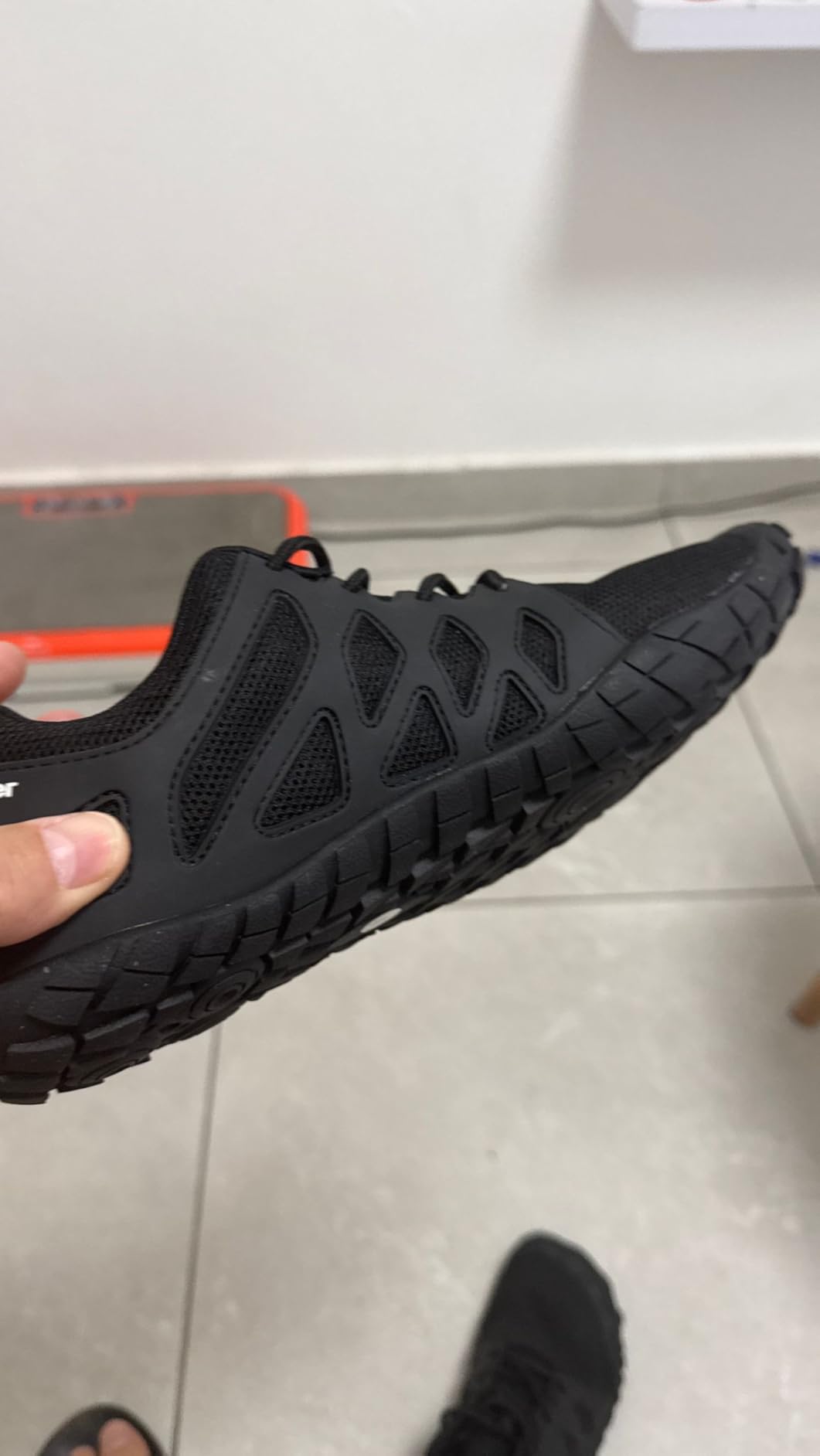 Side by side comparison showing wide Oranginer toe box versus narrow silhouette of traditional athletic training shoe