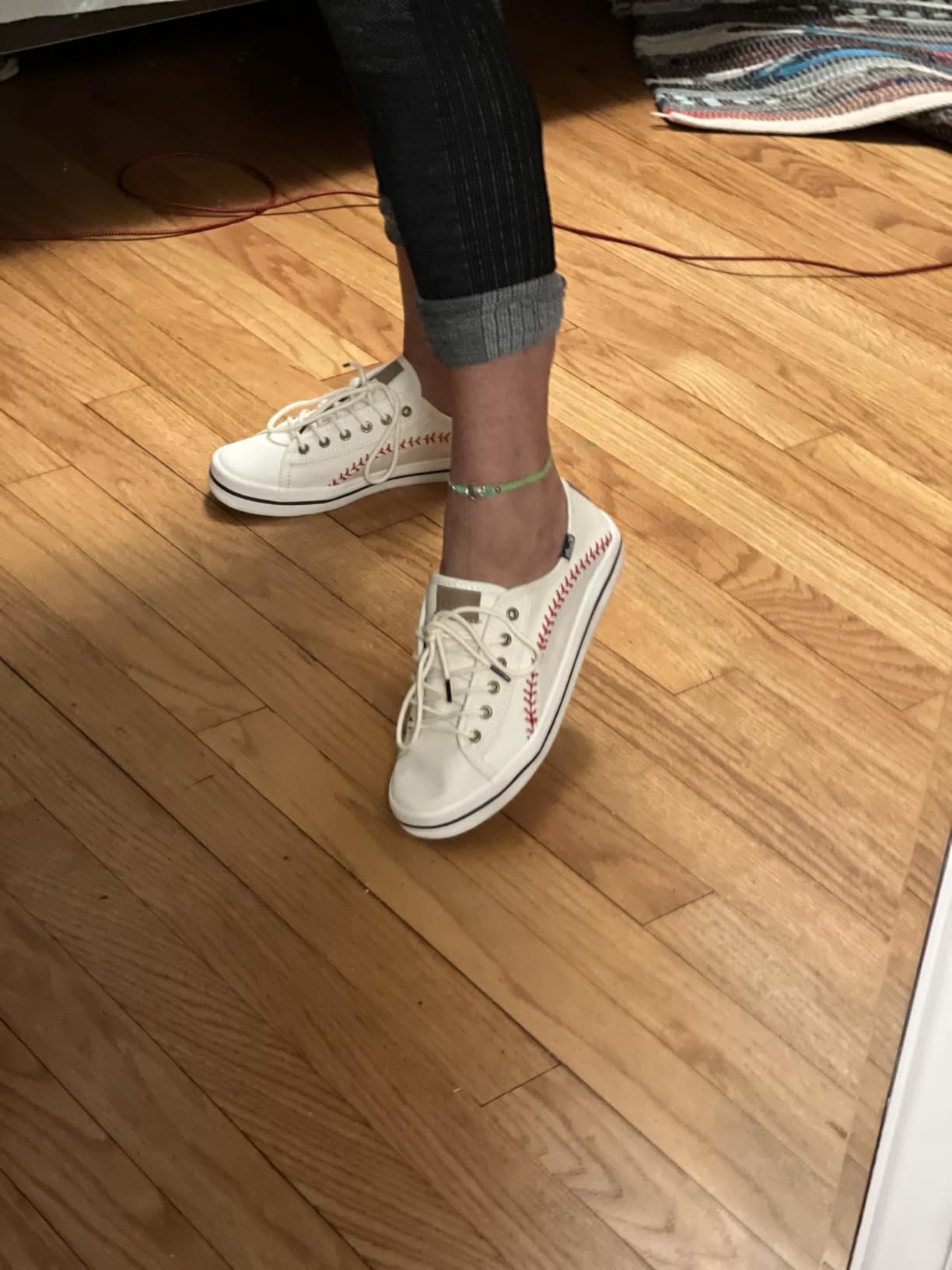 Close-up of Keds Kickstart Pennant canvas upper showing baseball stitching detail and dual lace options