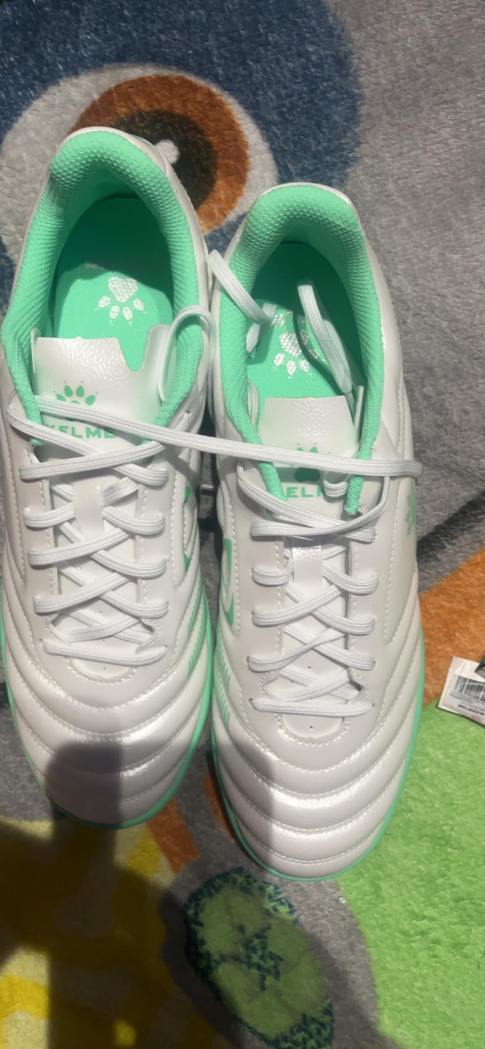 KELME turf shoes showing different colorway options and design variations available for men's indoor soccer