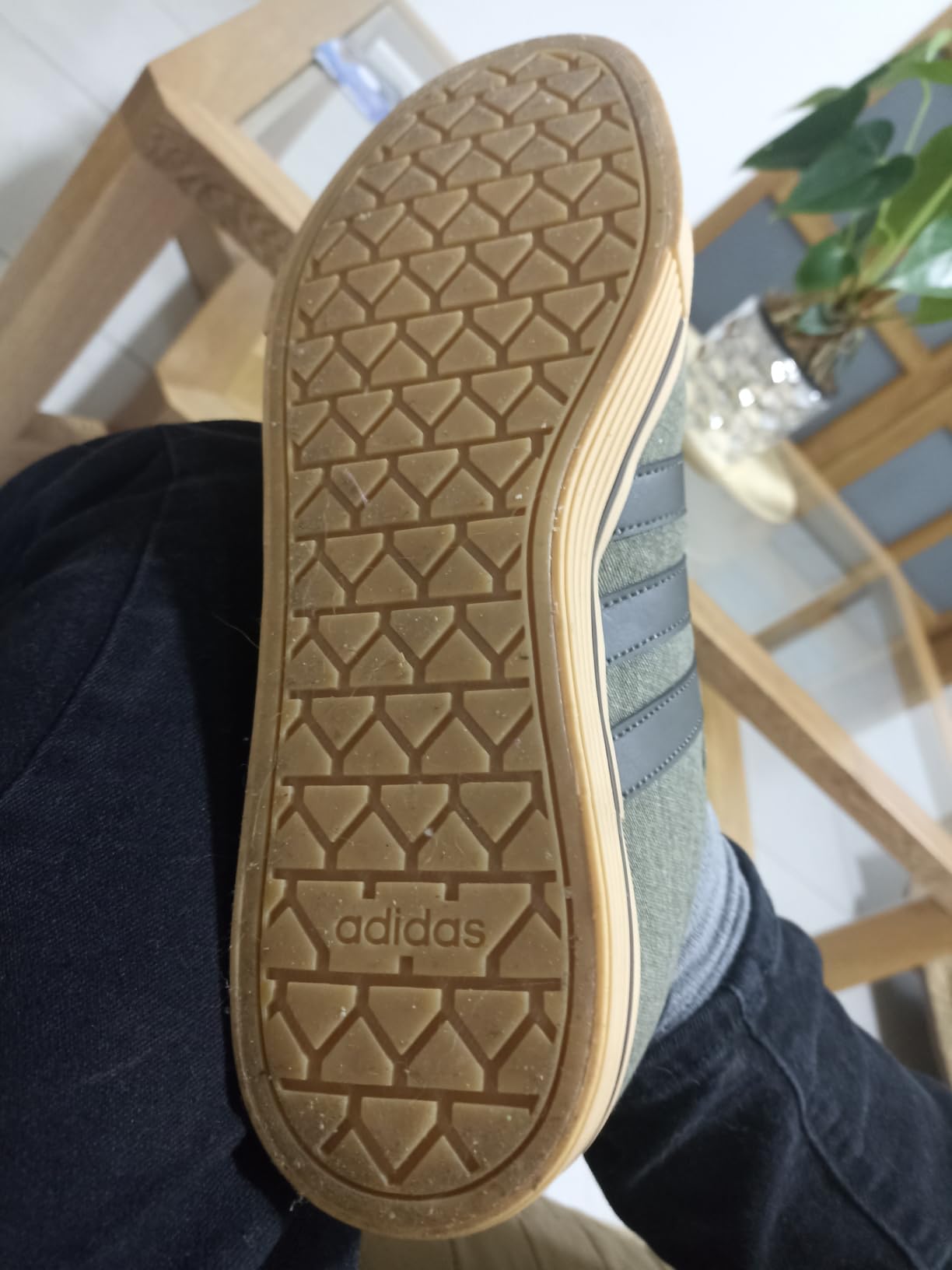 Side profile view of Adidas Daily 4.0 sneakers showing design and rubber outsole pattern