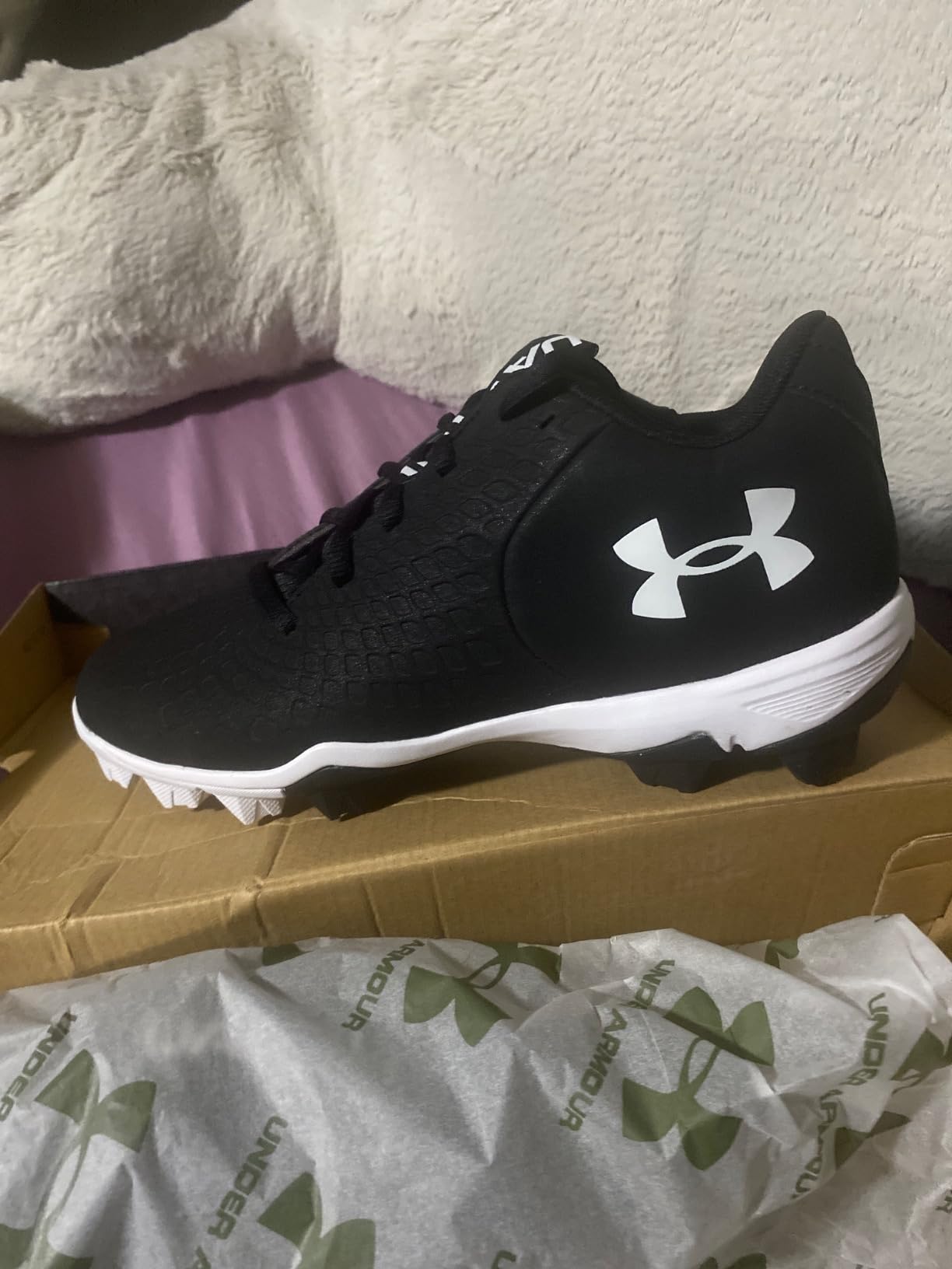 Detailed view of Under Armour Glyde 2.0 RM rubber molded cleat pattern designed for softball field traction