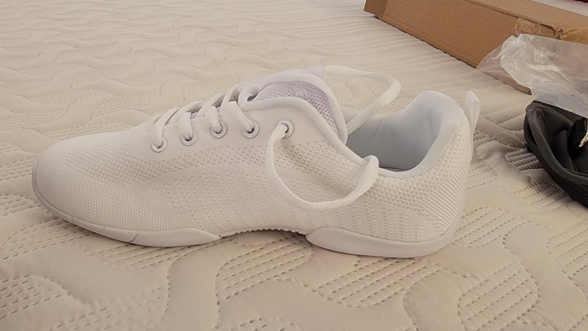 BAXINIER girls white cheerleading shoes showing mesh upper design and flexible sole construction