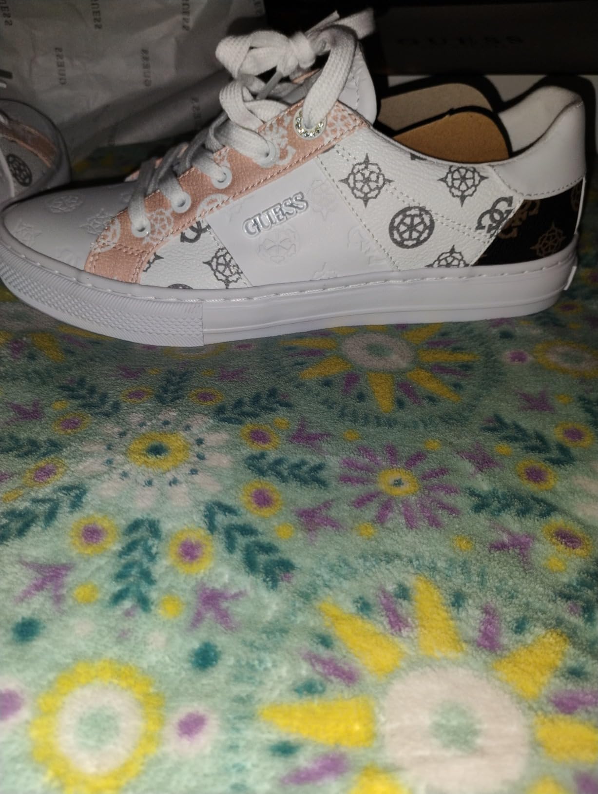 GUESS Women's Loven Sneaker worn in lifestyle setting showing outfit versatility options