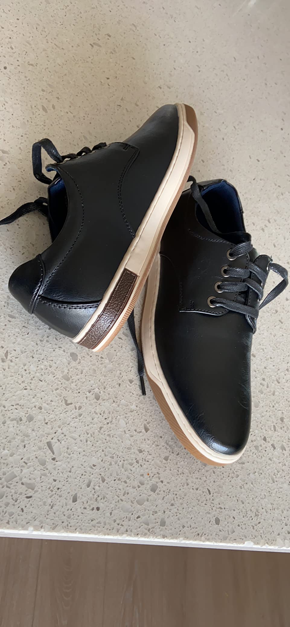 Close-up detail of Jousen dress sneaker showing faux leather upper texture and oxford lacing system with visible stitching detail