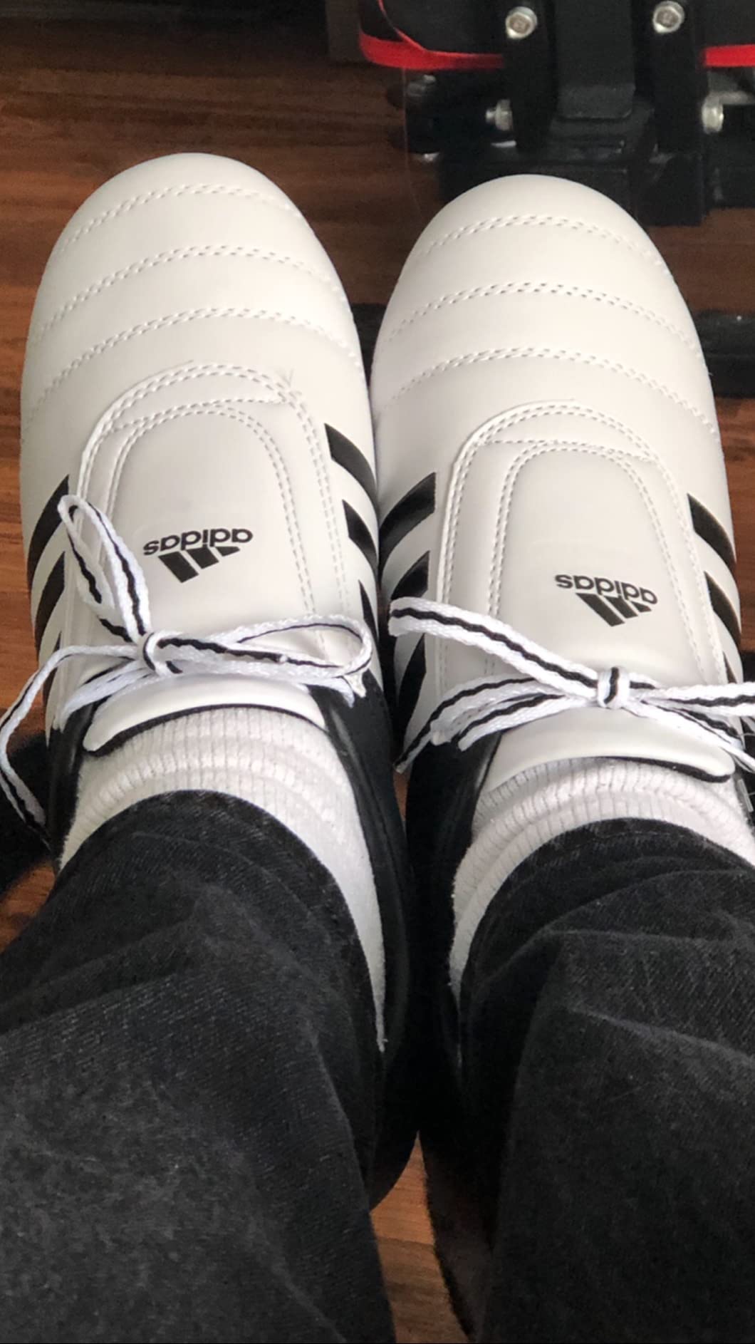 Adidas Adi-Kick II in use during Taekwondo training session demonstrating footwork and pivot capability on mats