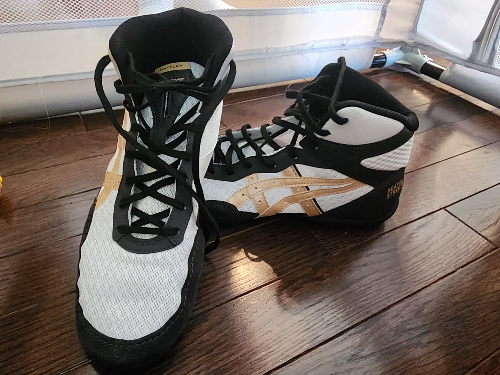 ASICS Matflex 7 black and gold colorway showing condition after extended wrestling use and durability testing