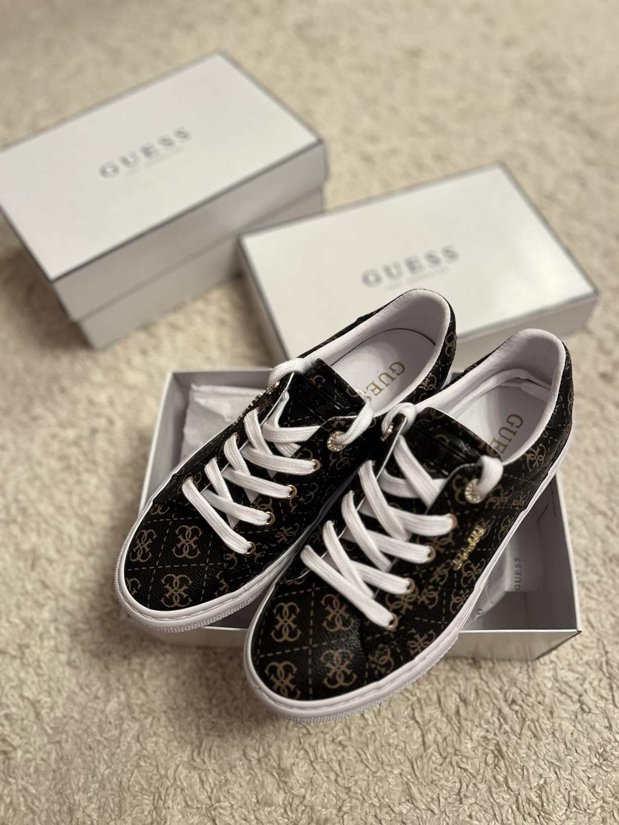 GUESS Women's Loven Sneaker styled with jeans showing versatile casual outfit pairing