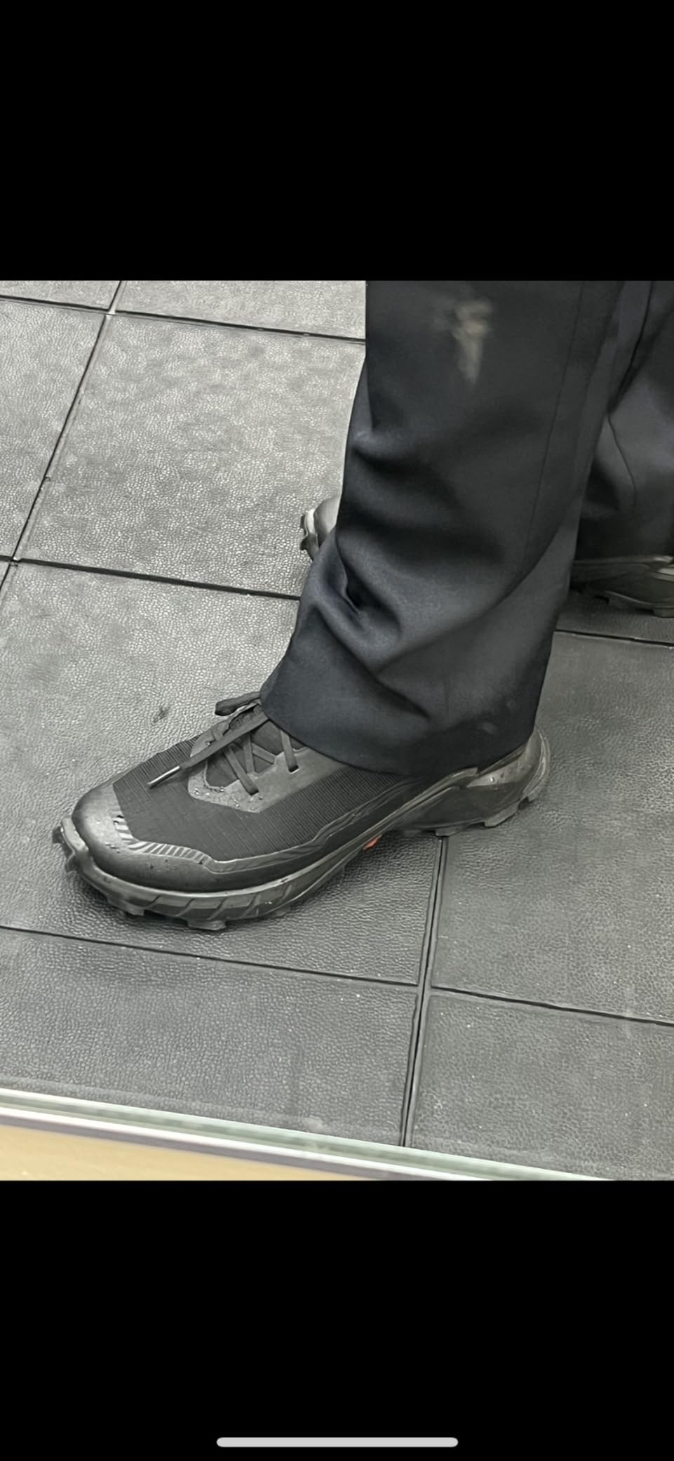 Salomon Alphacross 5 Gore-Tex being worn on muddy trail showing real-world trail performance