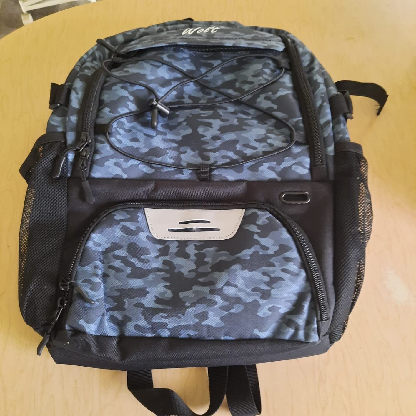 WOLT Basketball Backpack showing three-zone compartment organization — ball compartment top, shoe compartment bottom, main storage middle