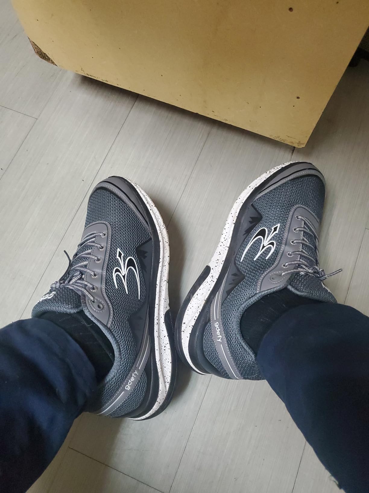 G-DEFY VersoShock technology diagram showing poly-flex spring system and reverse trampoline pad for shock absorption