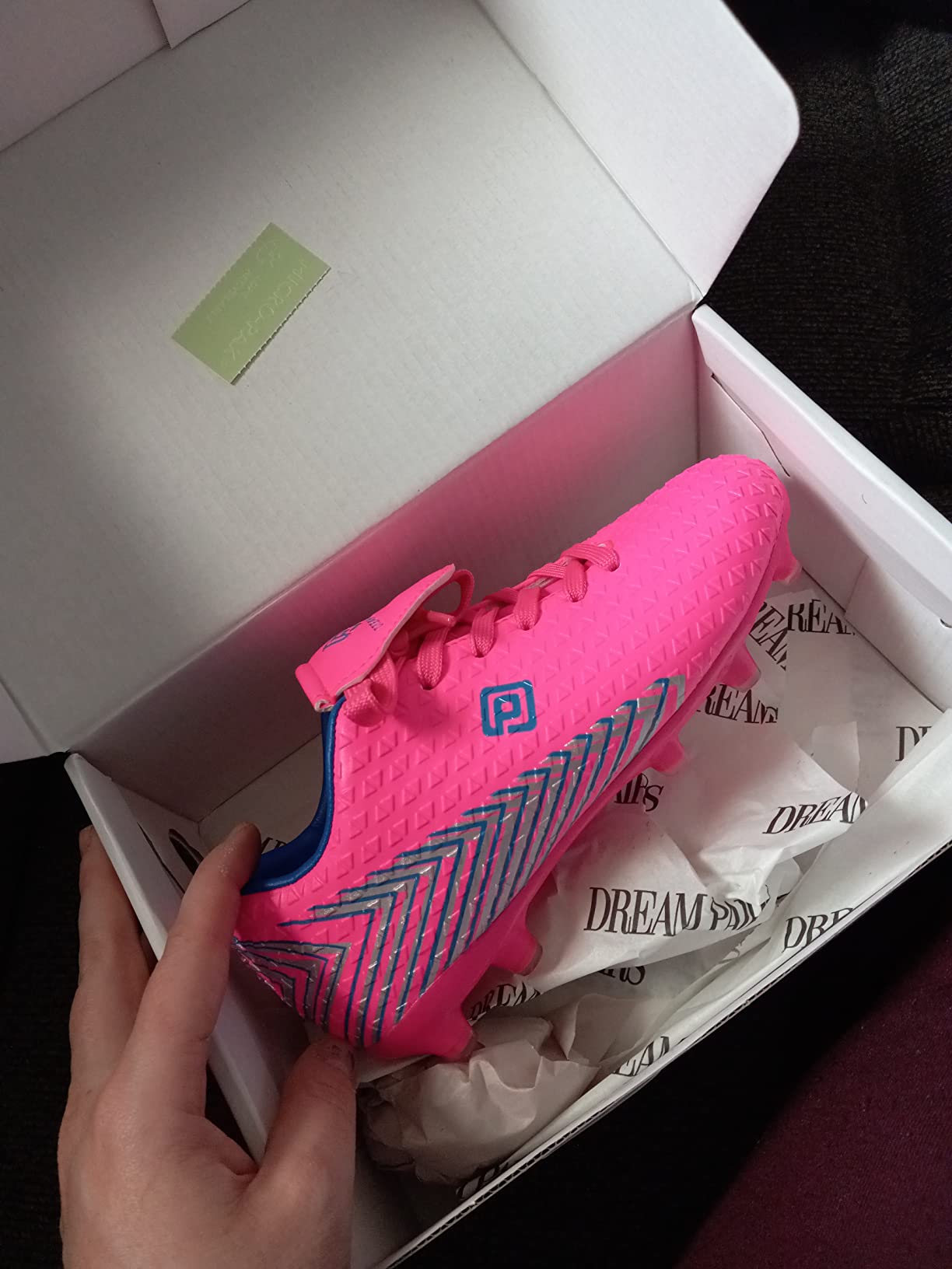 DREAM PAIRS soccer cleat sole close-up showing TPU injection-molded stud pattern for firm ground play