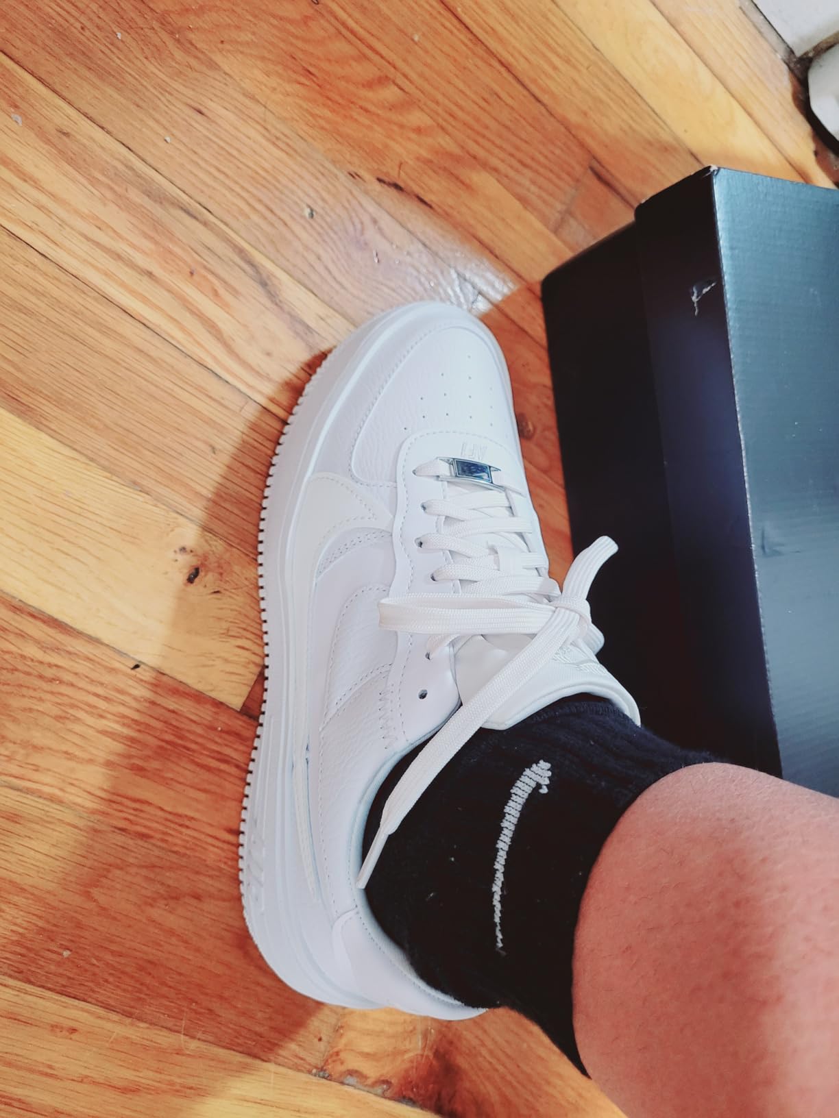 Nike Air Force 1 lacing system and Nike swoosh branding closeup