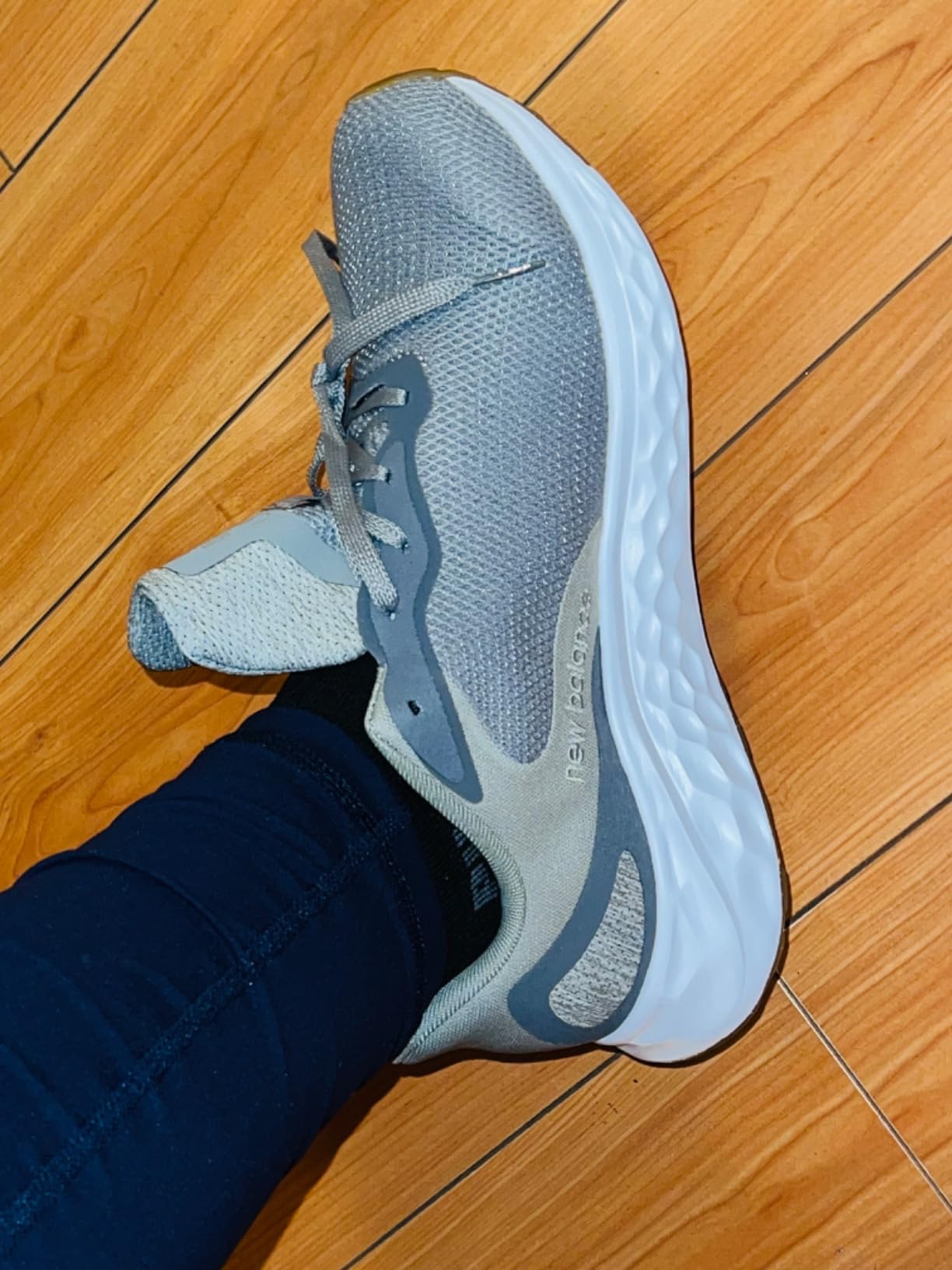 Action shot of New Balance Arishi V4 during outdoor running showing tread pattern and real-world performance