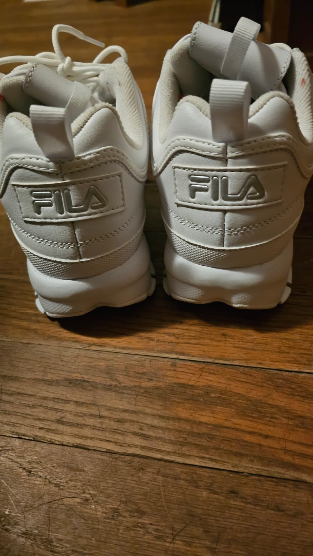 Fila Disruptor II product detail close-up showing brand logo placement and leather construction quality