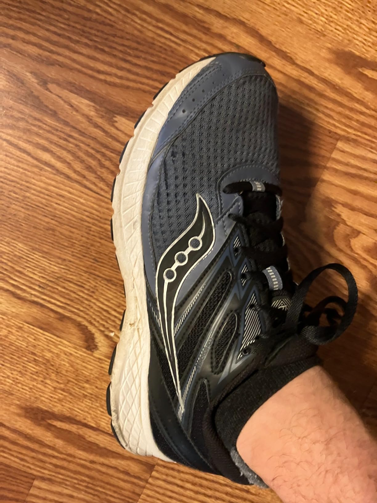 Close-up view of Saucony Cohesion 13 mesh upper construction and synthetic overlays