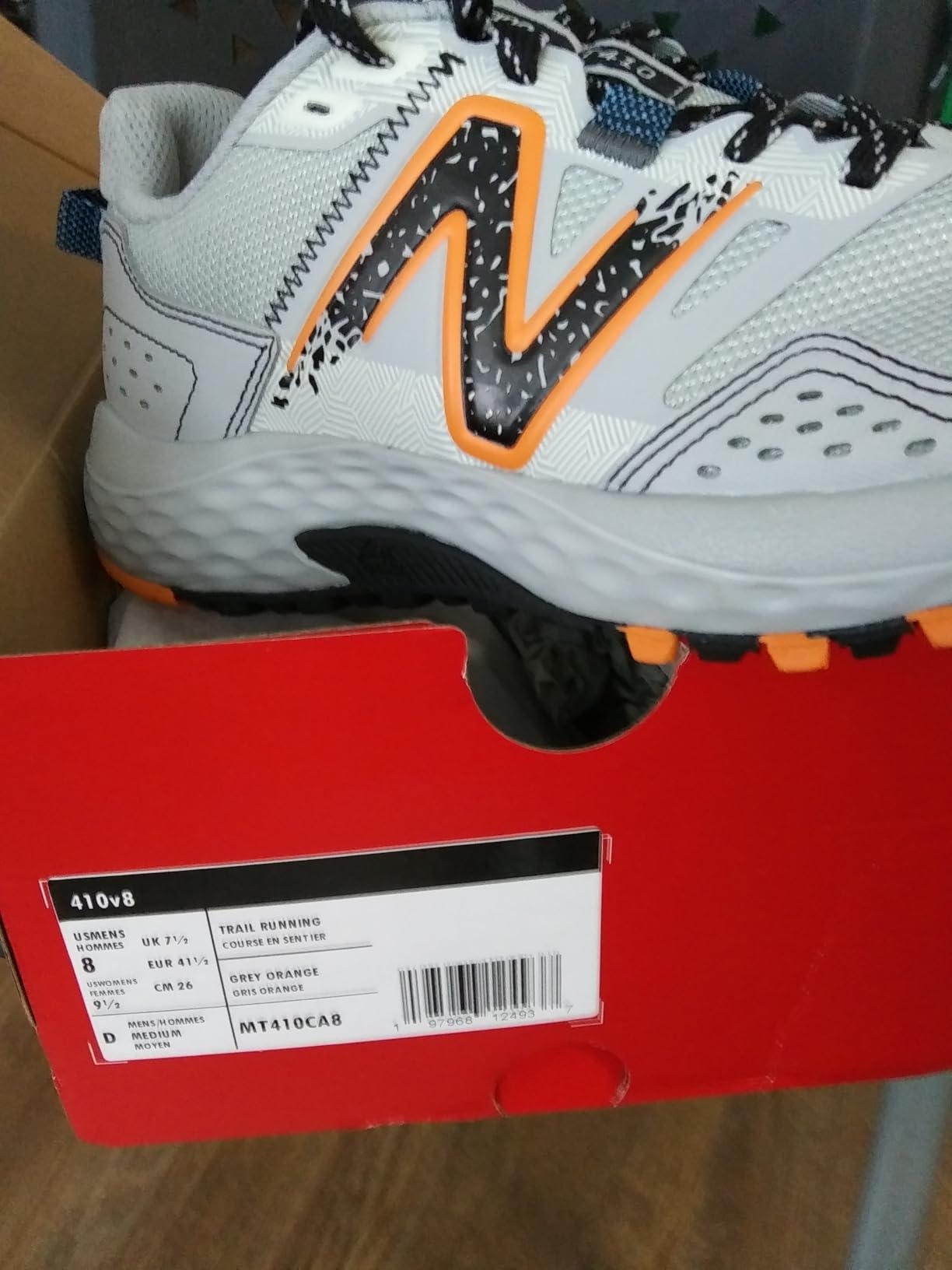 New Balance MT410 V8 trail running shoe showing synthetic upper construction and AT Tread outsole design