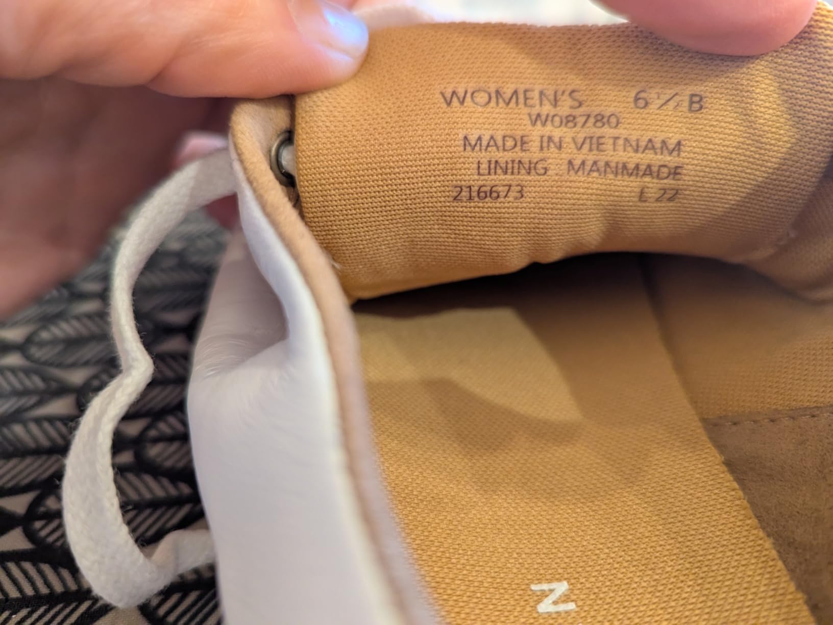 Side view of Cole Haan Grand Crosscourt showing heel height and ankle collar area