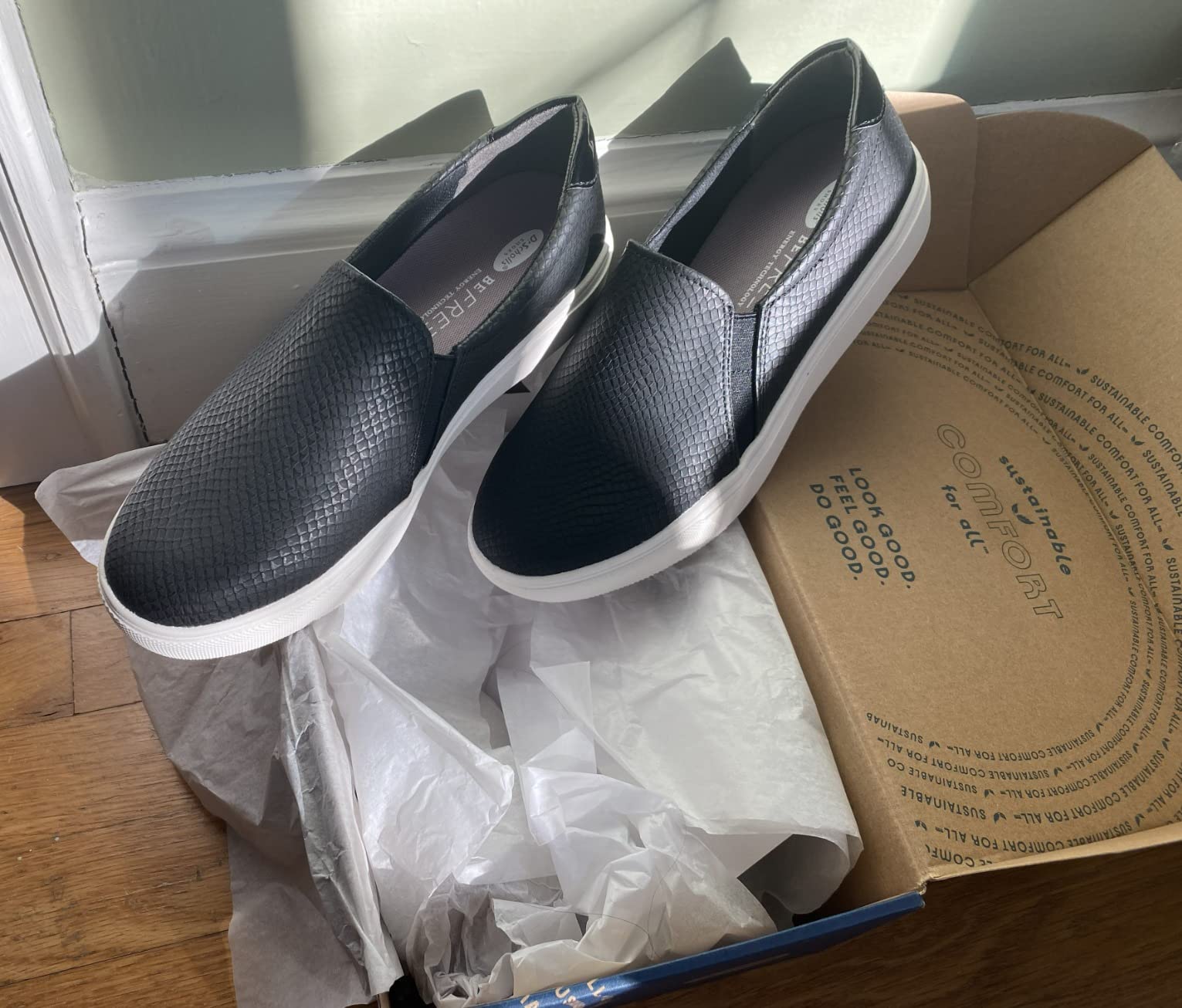 Dr. Scholl's Women's Nova slip-on sneakers in black showing sleek profile and platform sole construction