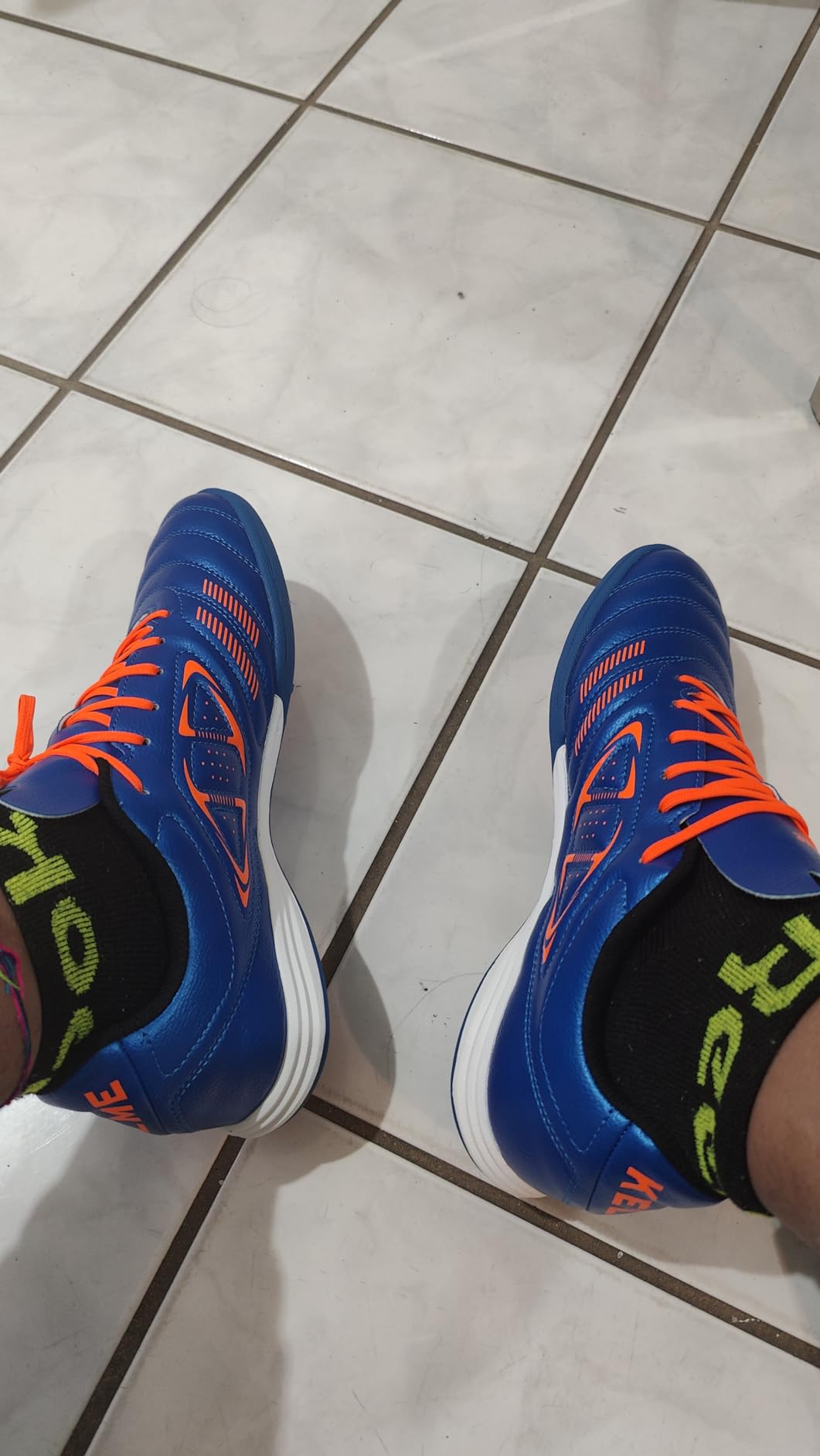 KELME turf shoes showing excessive toe box spacing and length comparison demonstrating how the shoes run 1.5-2 sizes larger than standard sizing