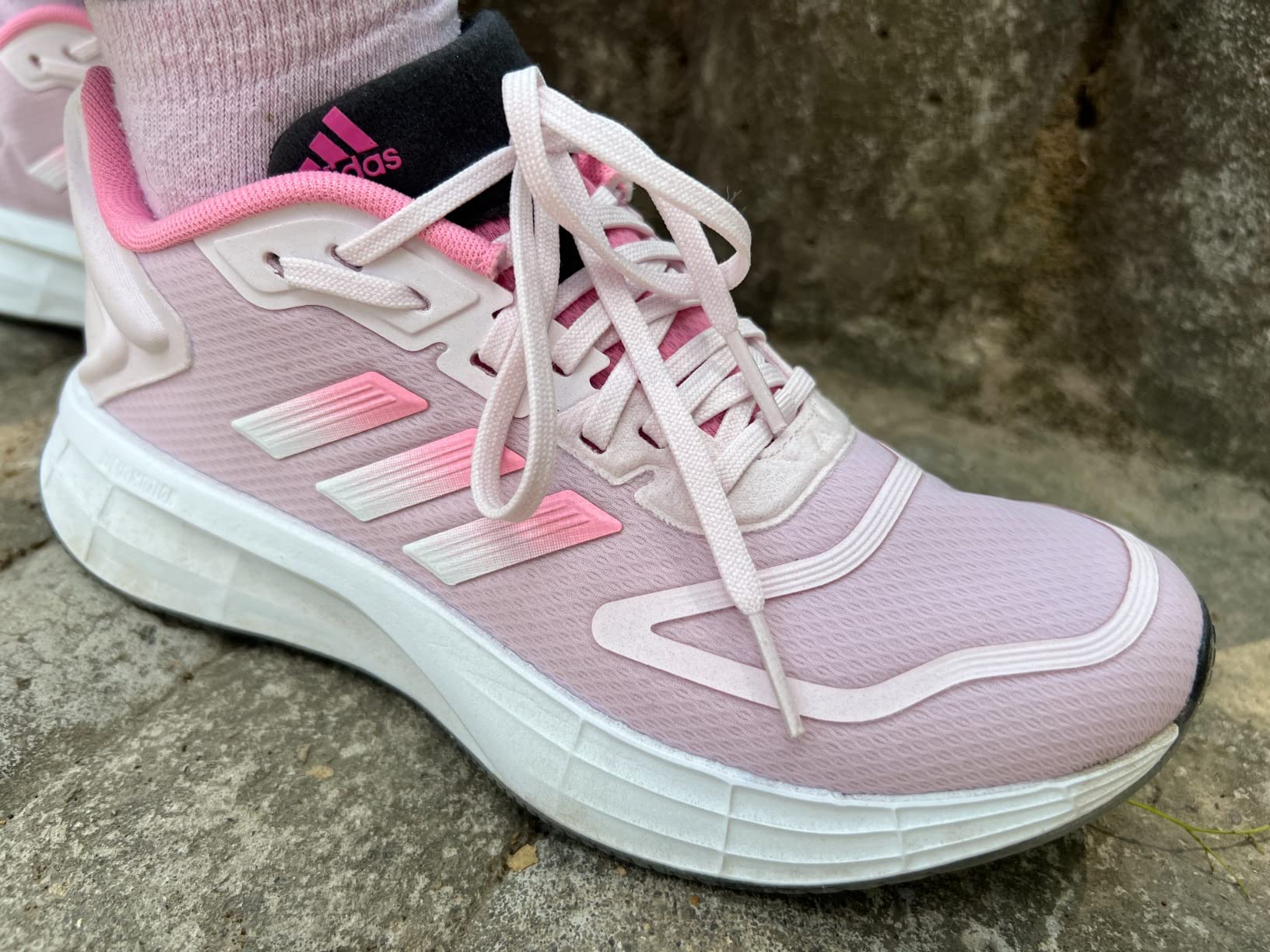 Adidas Duramo SL 2.0 in action during outdoor running session showing versatility for different activities and surfaces