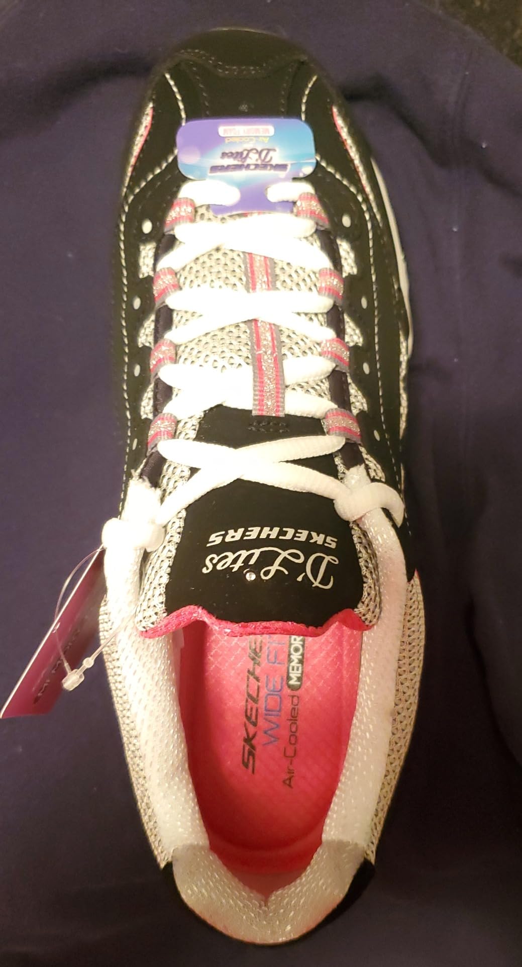 Side view of the Skechers D'Lites sneaker showing the layered leather and synthetic upper construction.