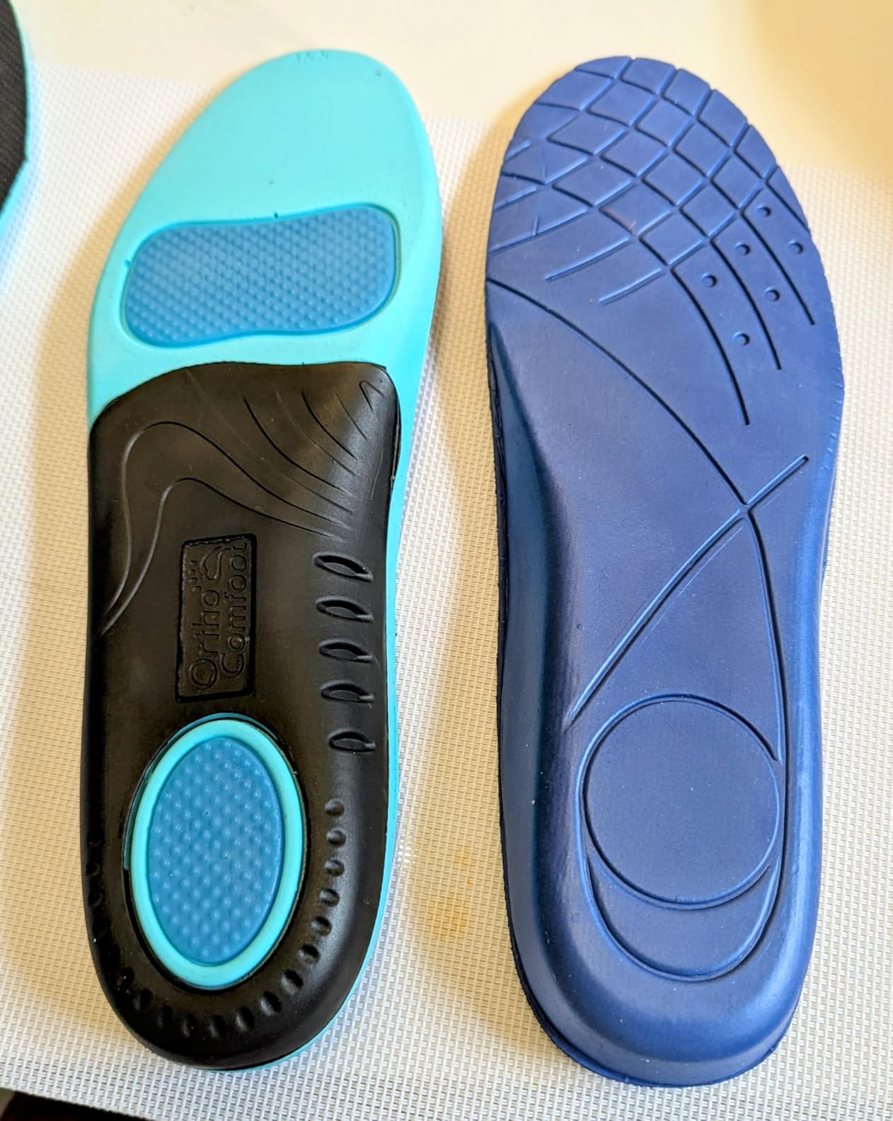OrthoComfoot orthopedic insoles showing TPU arch support construction with gel cushioning and memory foam layers