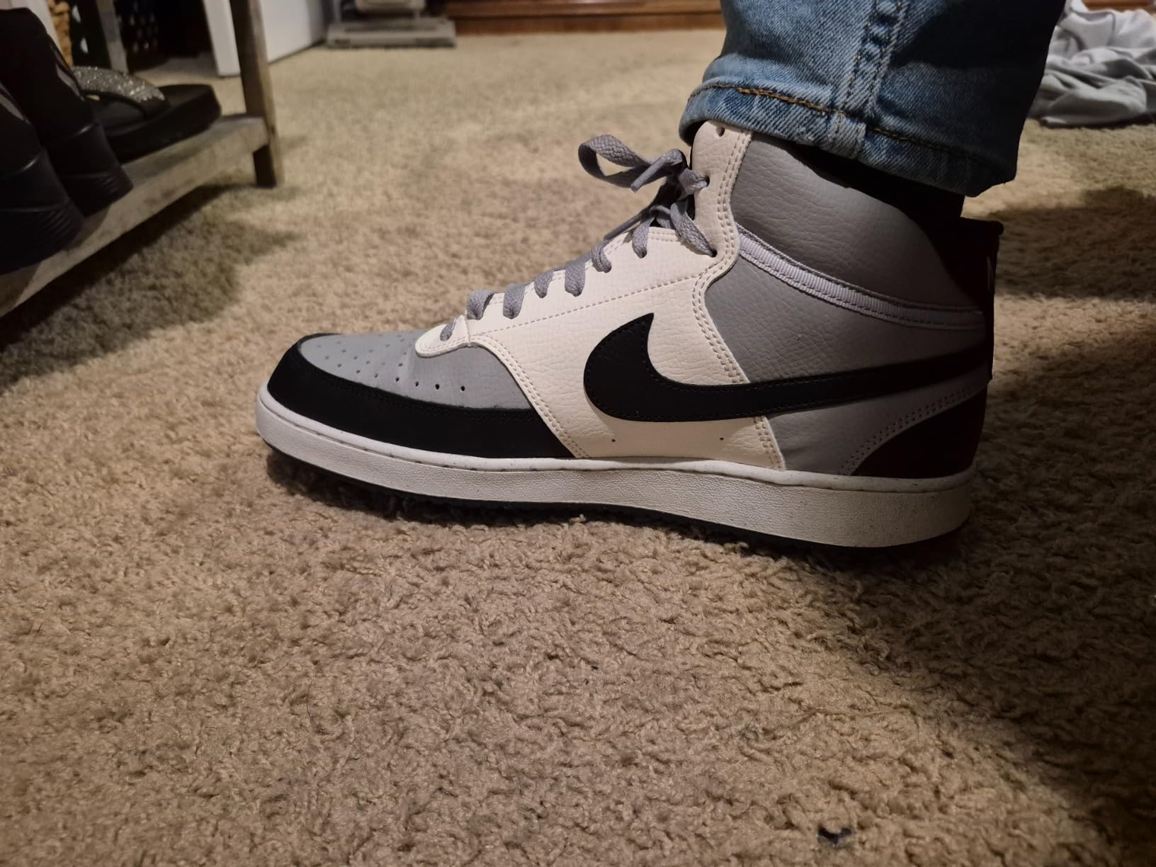 Nike Court Vision Mid side profile showing mid-top silhouette and stitched overlay construction detail