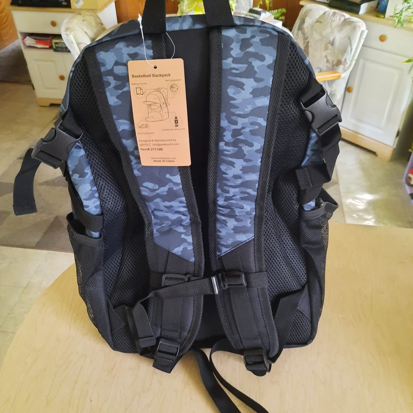WOLT Basketball Backpack shoe compartment detail showing ventilation holes and storage dimensions