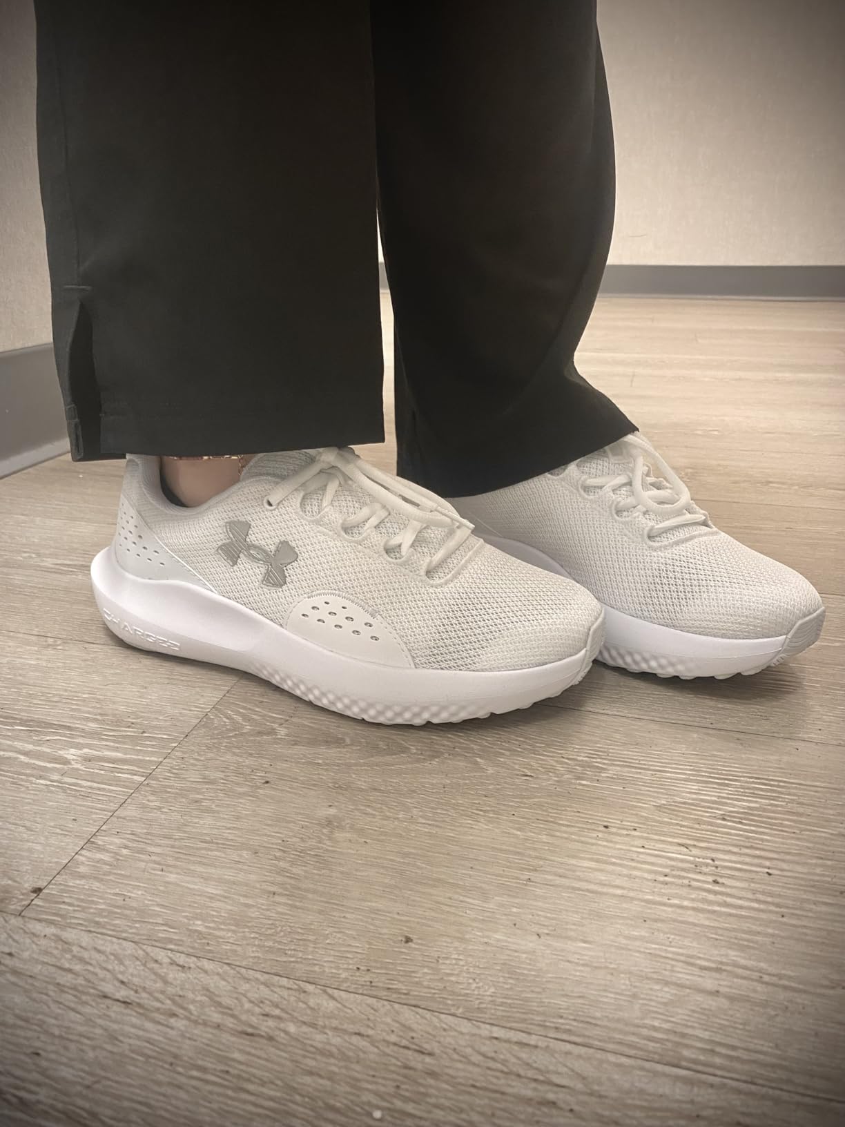 Under Armour Women's Charged Surge 4 in white distant grey colorway showing mesh upper and EVA midsole