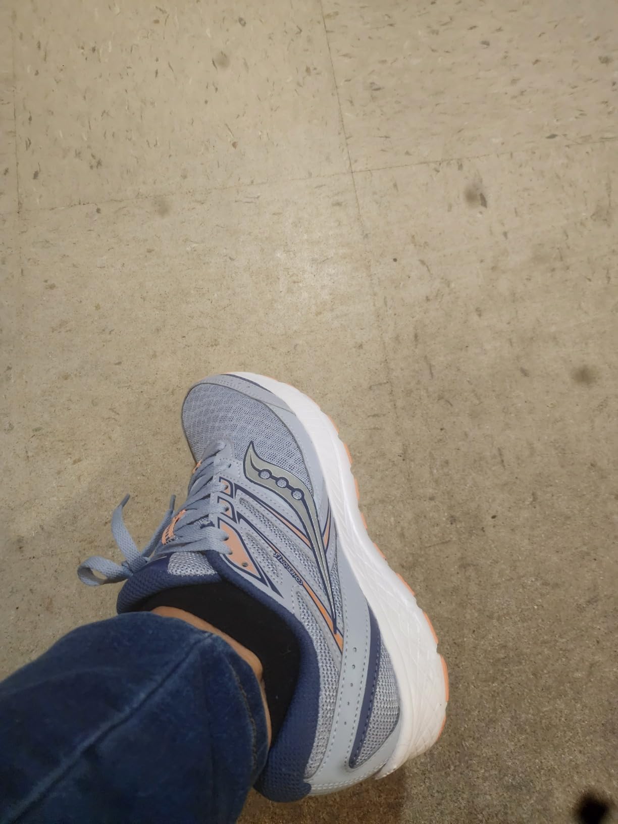 Multiple Saucony Women's Cohesion 13 shoes showing different colorway options including navy, gray, and pink